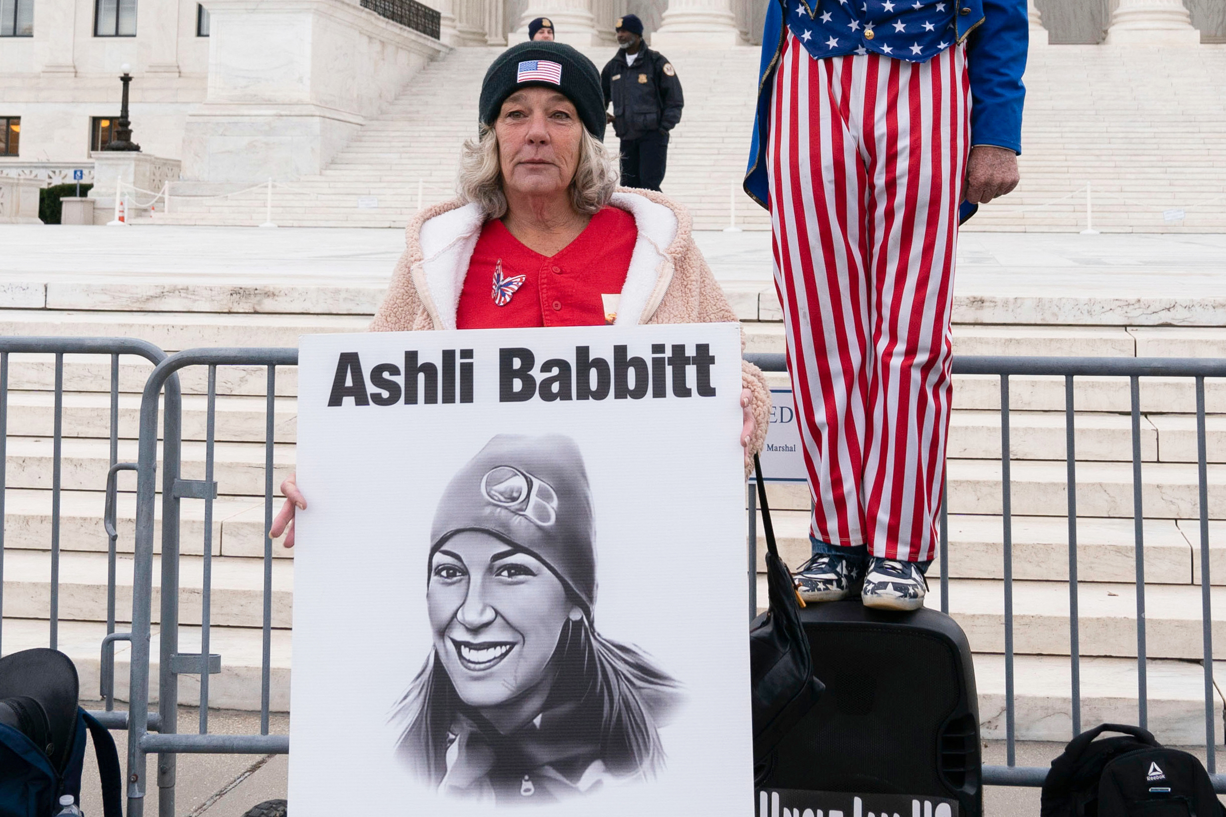 FILE - Micki Witthoeft, center, mother of Ashli Babbitt, the woman fatally shot by police inside the U.S. Capitol during the Jan. 6, 2021, riot, joins protesters outside of the Supreme Court on the second anniversary of the Jan. 6, assault on the U.S. Capitol, in Washington,, Jan. 6, 2023. (AP Photo/Jose Luis Magana)