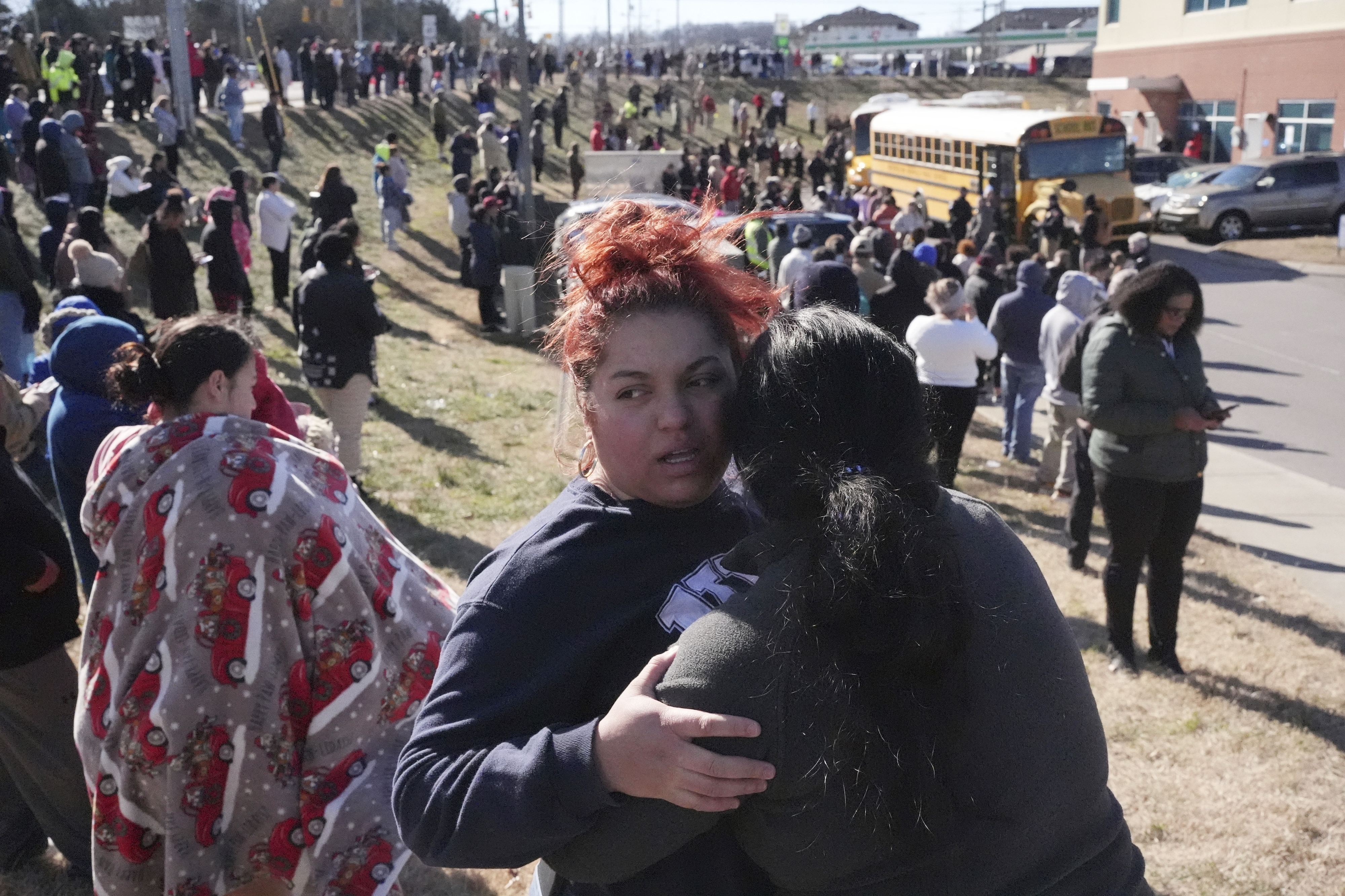 FILE - Families wait as school buses arrive at a unification site following a shooting at the Antioch High School in Nashville, Tenn., Wednesday, Jan. 22, 2025. (AP Photo/George Walker IV, File)