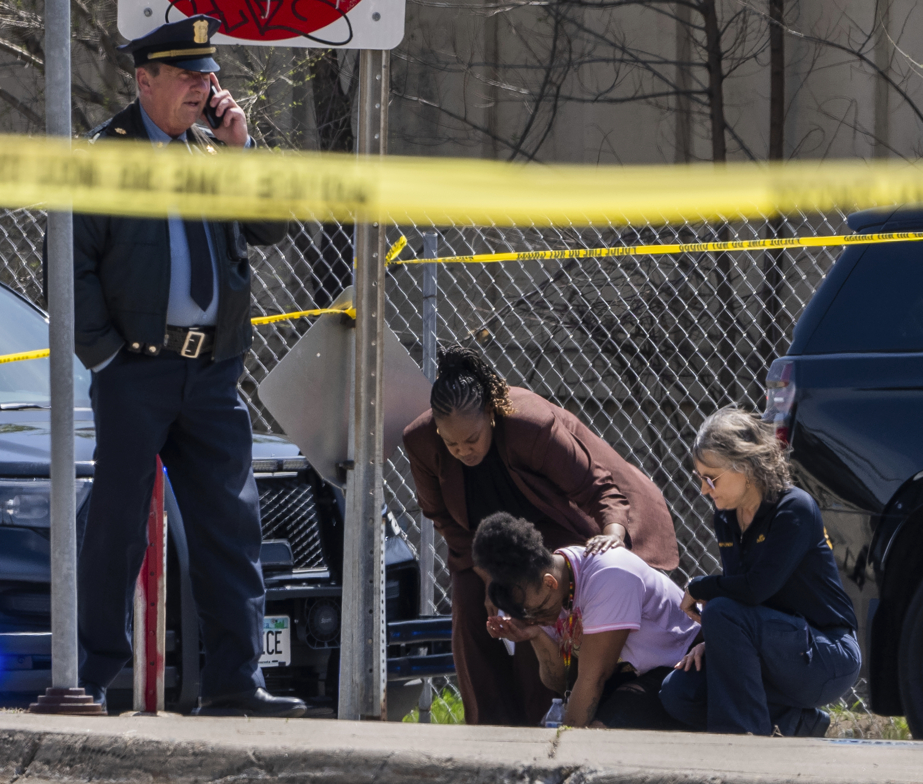 A police officer works on the scene as a bystander is shook up by the homicide in front of 2107 Cedar Ave S in Minneapolis, Minn., on Wednesday, April 30, 2025. (Richard Tsong-Taatarii/Star Tribune via AP)