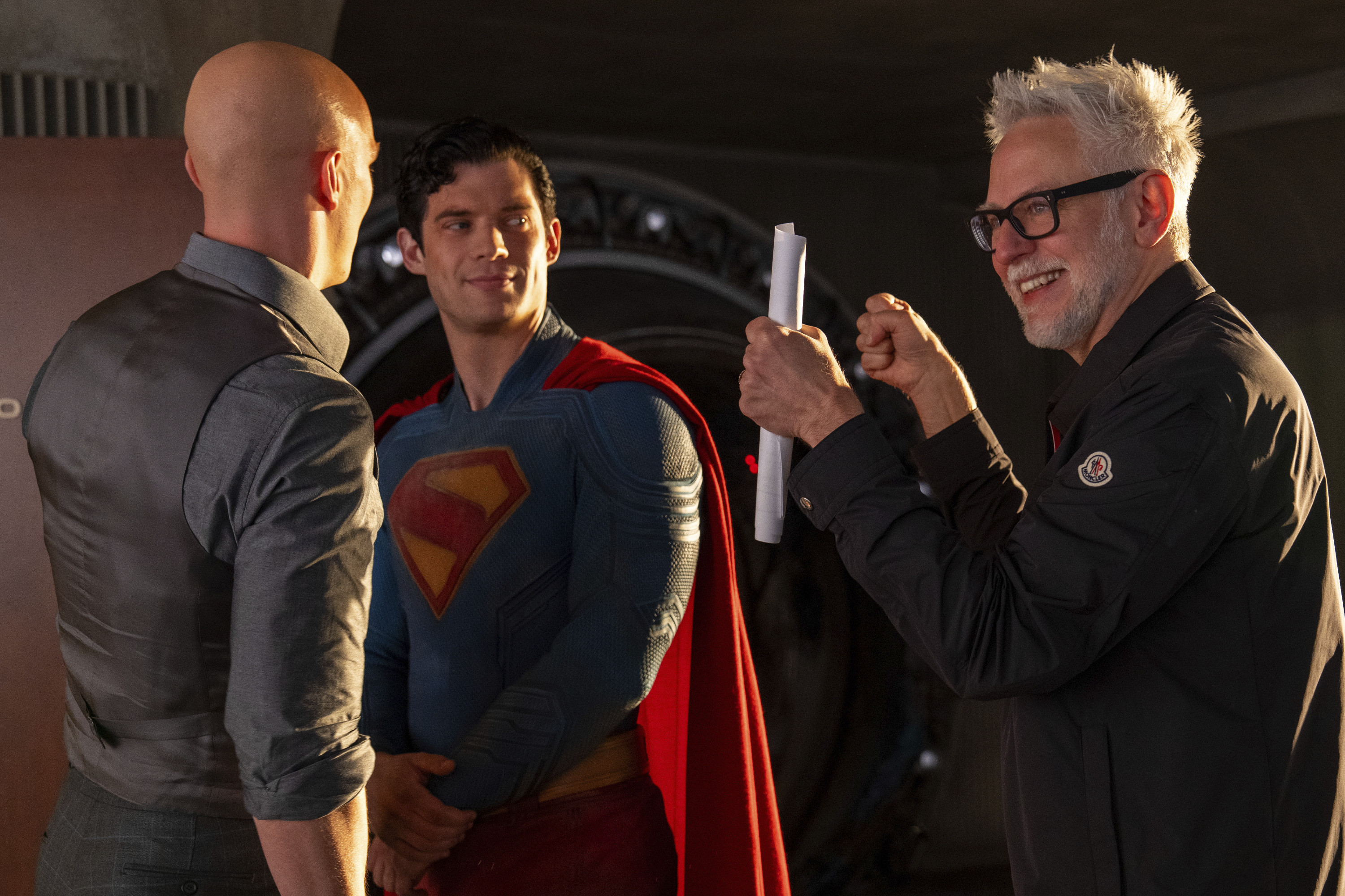 This image released by Warner Bros. Pictures shows Nicholas Hoult, left, David Corenswet, center, and director James Gunn on the set of "Superman." (Jessica Miglio/Warner Bros. Pictures via AP)