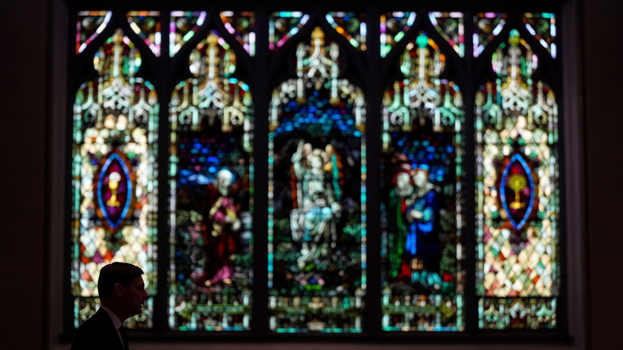 B.C. Premier David Eby is silhouetted while speaking after mass at Holy Rosary Cathedral on a provincial day of mourning for the victims of the vehicle-ramming attack at the Filipino community's Lapu Lapu Day festival last week, in Vancouver, on Friday, May 2, 2025. (Darryl Dyck/The Canadian Press via AP)