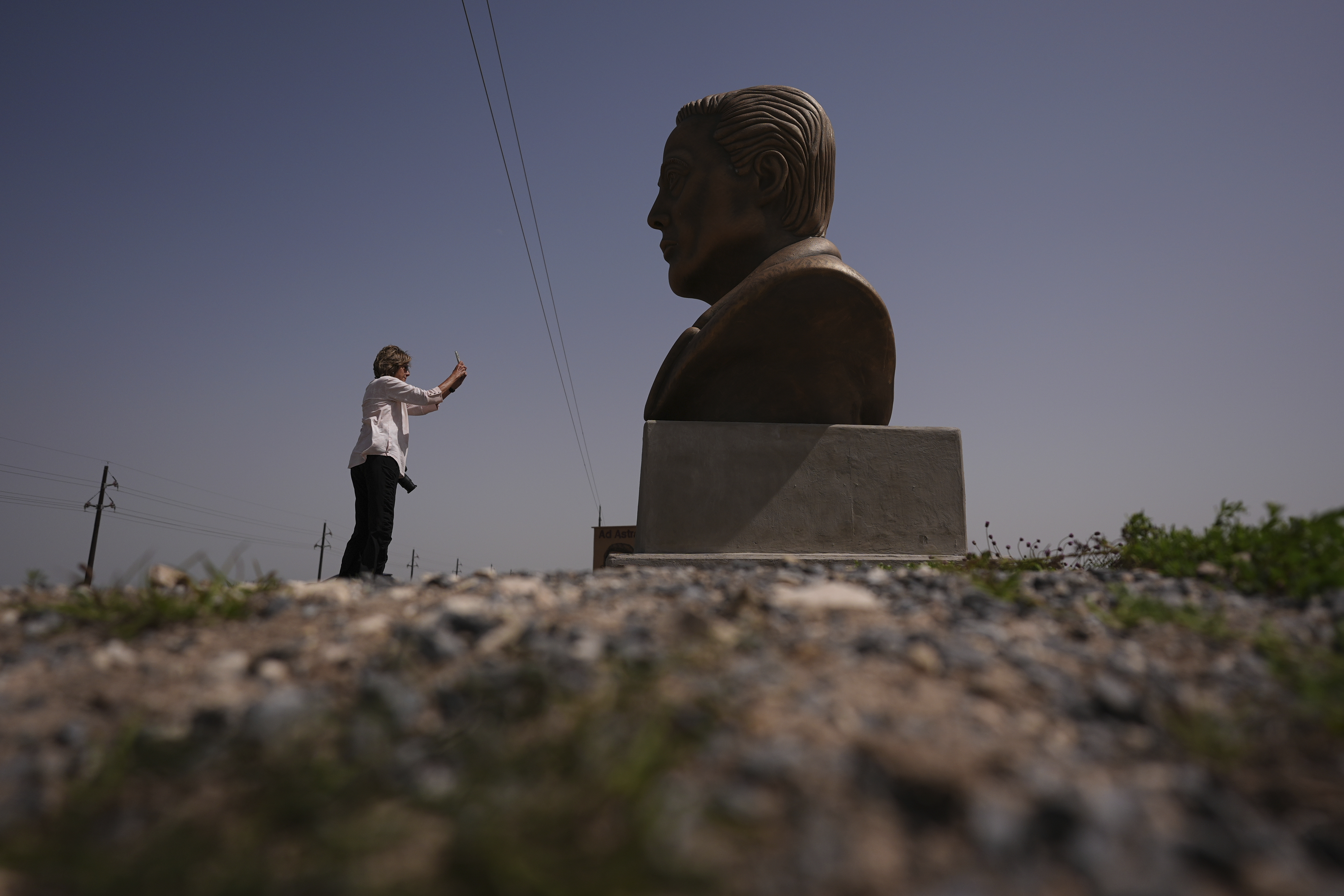 FILE - A visitor photographs a large bust of Elon Musk near SpaceX's Starbase as the Starship is prepared for a test flight in Boca Chica, Texas, March 5, 2025. (AP Photo/Eric Gay, File)