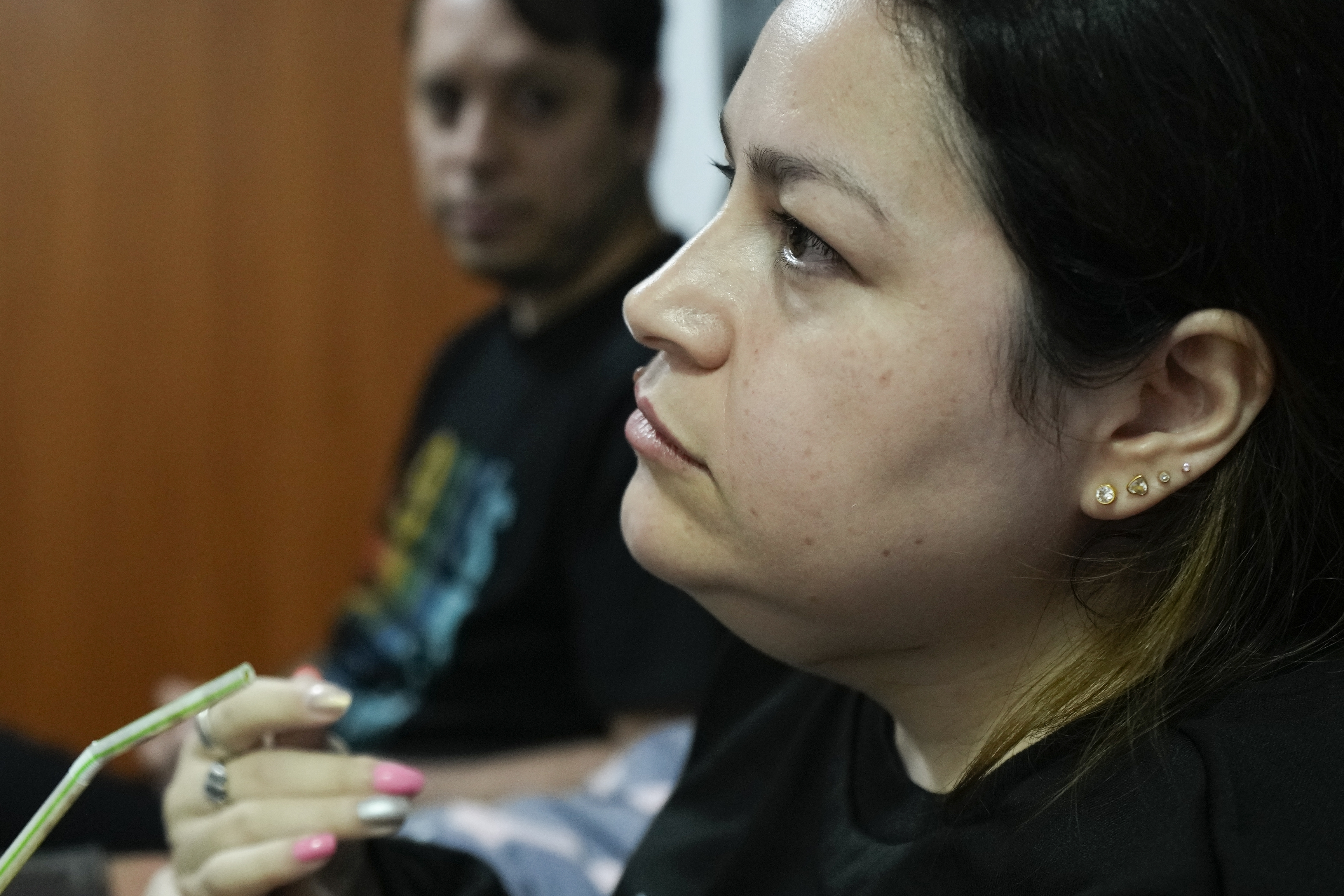 Susana Moreira, 41, a degenerative muscular dystrophy patient, gives an interview in her bedroom in Santiago, Chile, Monday, April 7, 2025. (AP Photo/Esteban Felix)