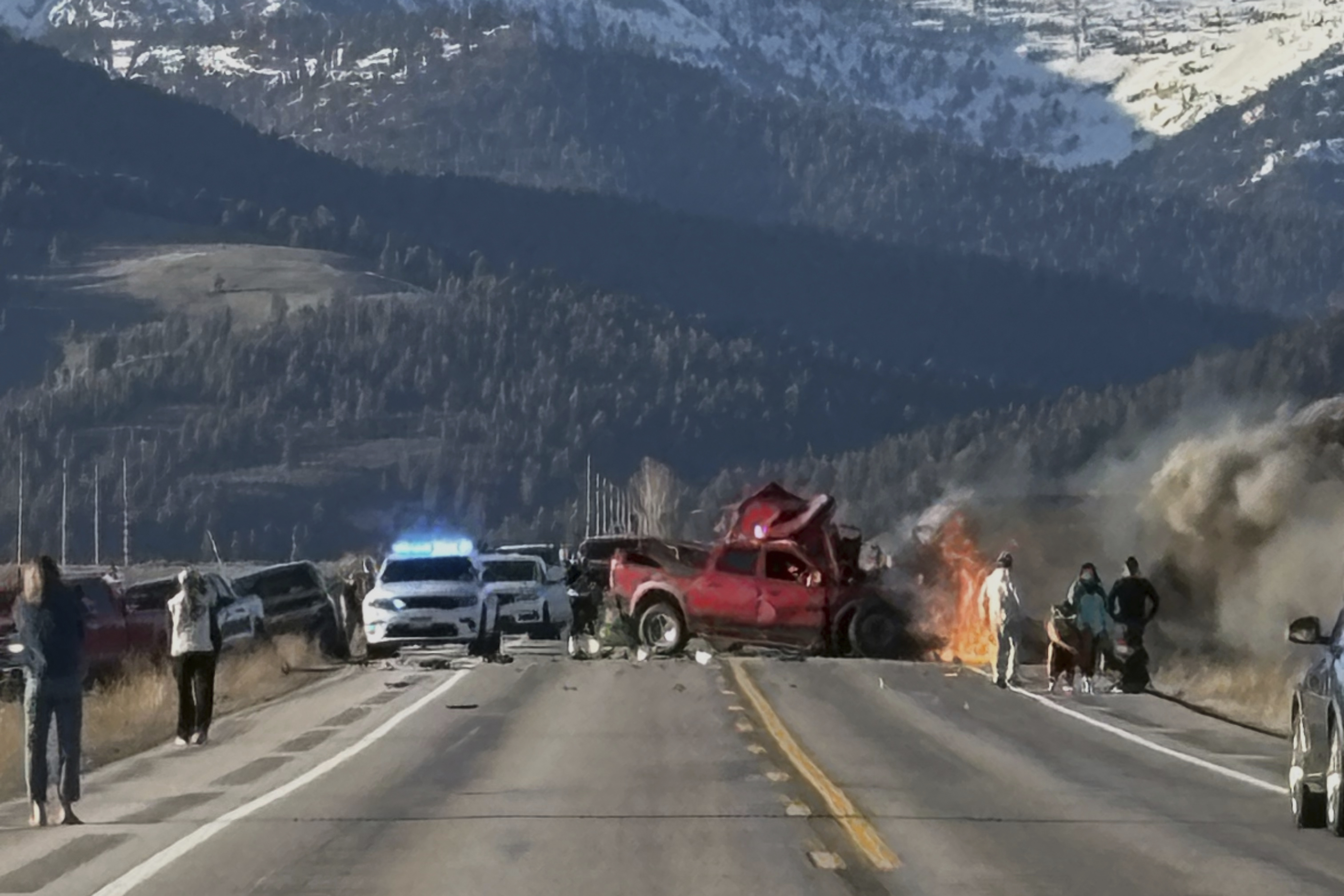 Rescue workers arrive to the scene after a deadly collision between a pickup truck and tour van near Henry’s Lake State Park in eastern Idaho on Thursday, May 1, 2025. (Roger Merrill via AP)