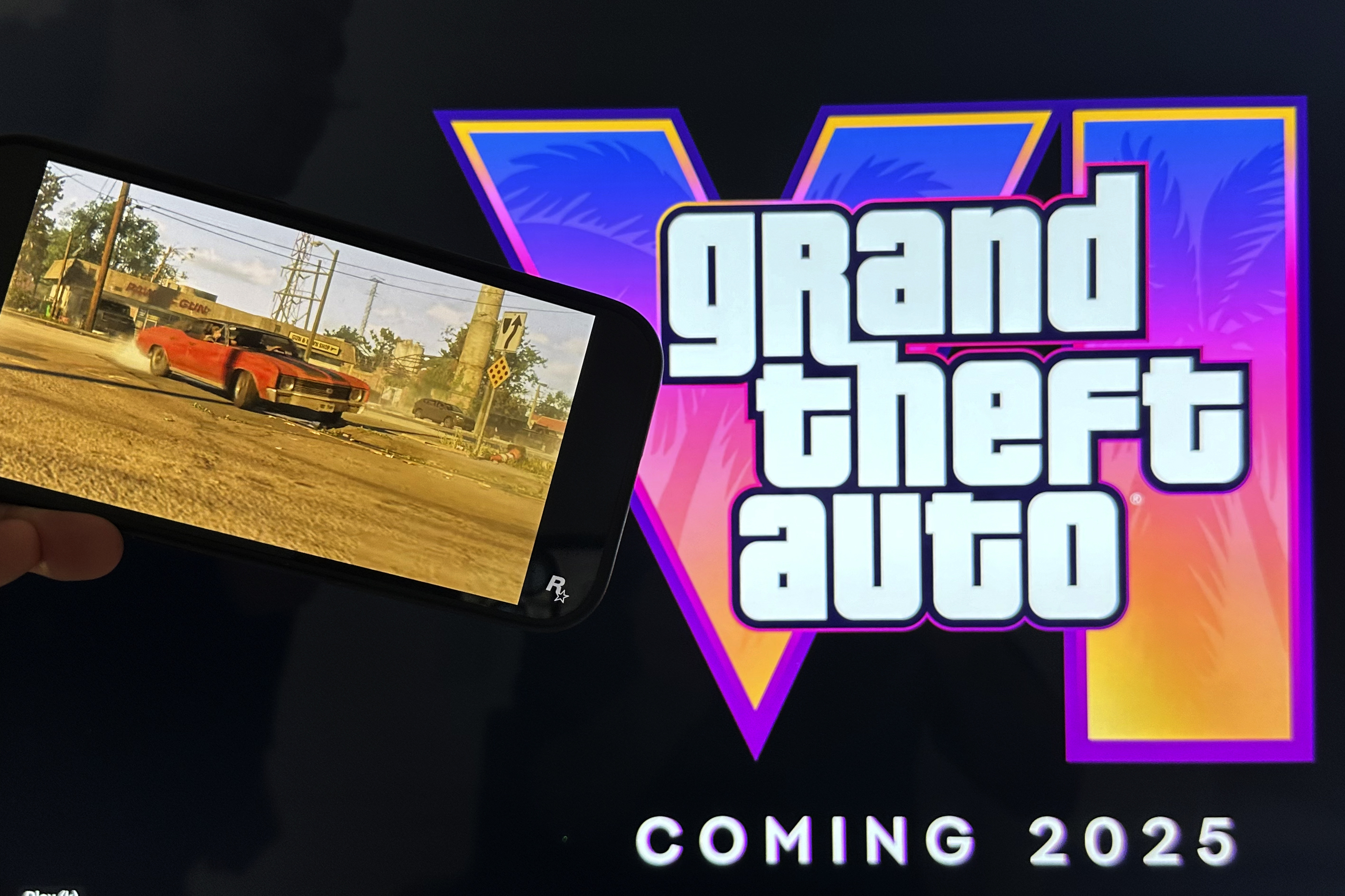 FILE - Scenes from the trailer of Grand Theft Auto VI are shown on a smartphone and monitor in New York on Tuesday, Dec. 5, 2023. (AP Photo/Peter Morgan, File)