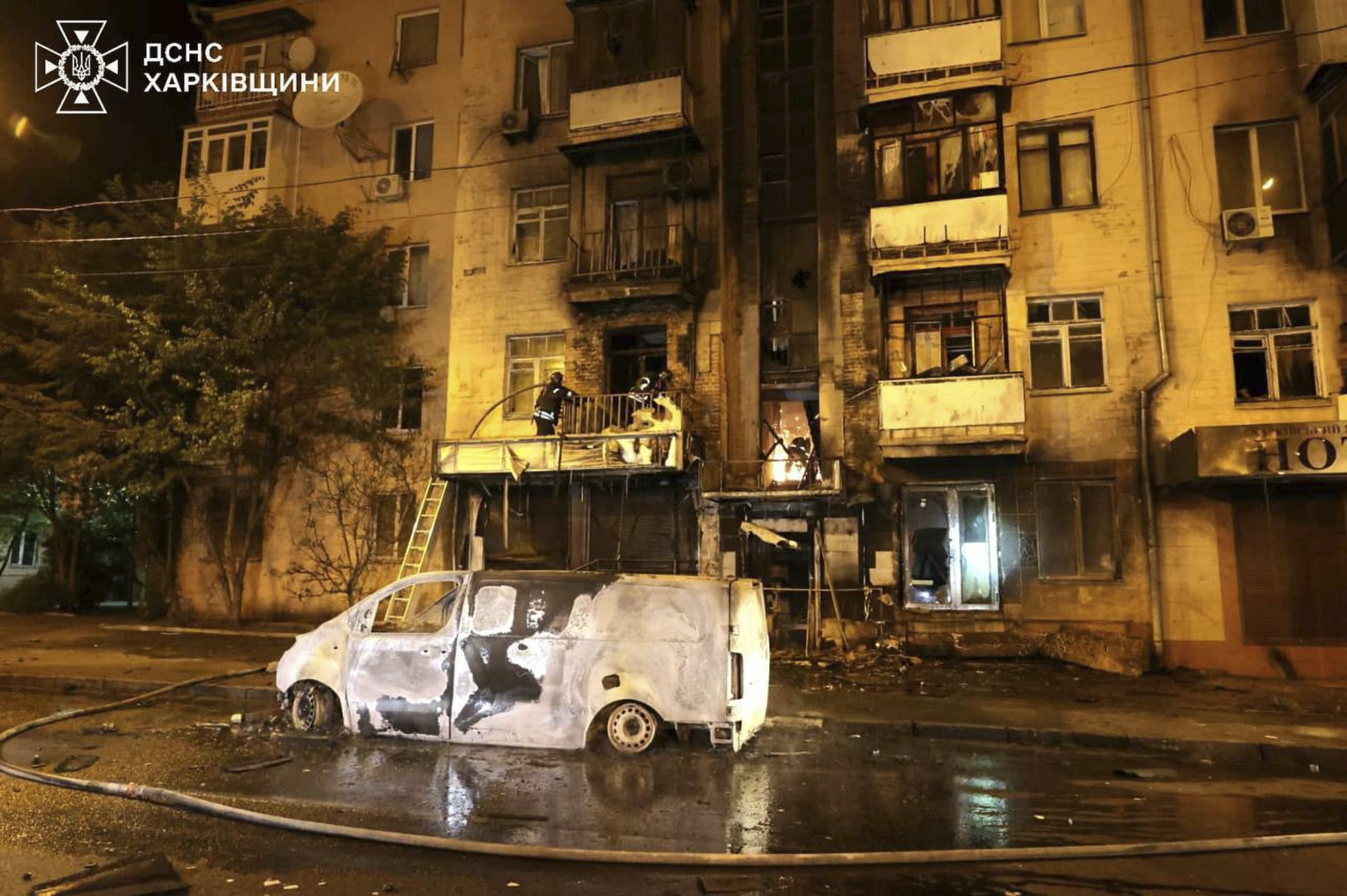 In this photo provided by the Ukrainian Emergency Service, emergency services personnel work to extinguish a fire following a Russian attack in Kharkiv, Ukraine, Saturday, May 3, 2025. (Ukrainian Emergency Service via AP)