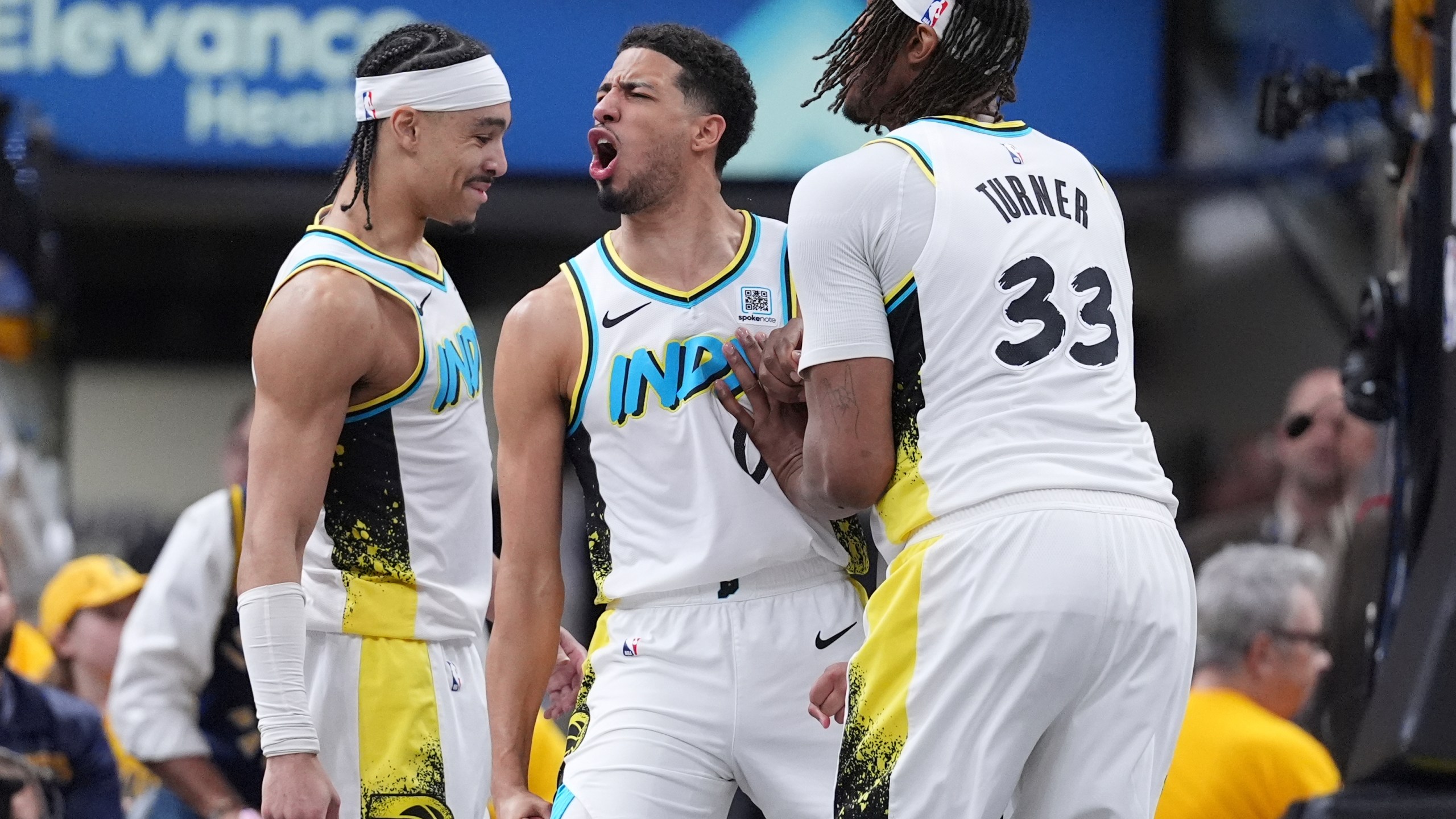 Indiana Pacers guard Tyrese Haliburton, center, celebrates a defensive play with teammates Andrew Nembhard, left, and center Myles Turner (33) during the second half in Game 5 of an NBA basketball first-round playoff series against the Indiana Pacers, in Indianapolis, Tuesday, April 29, 2025. (AP Photo/Michael Conroy)