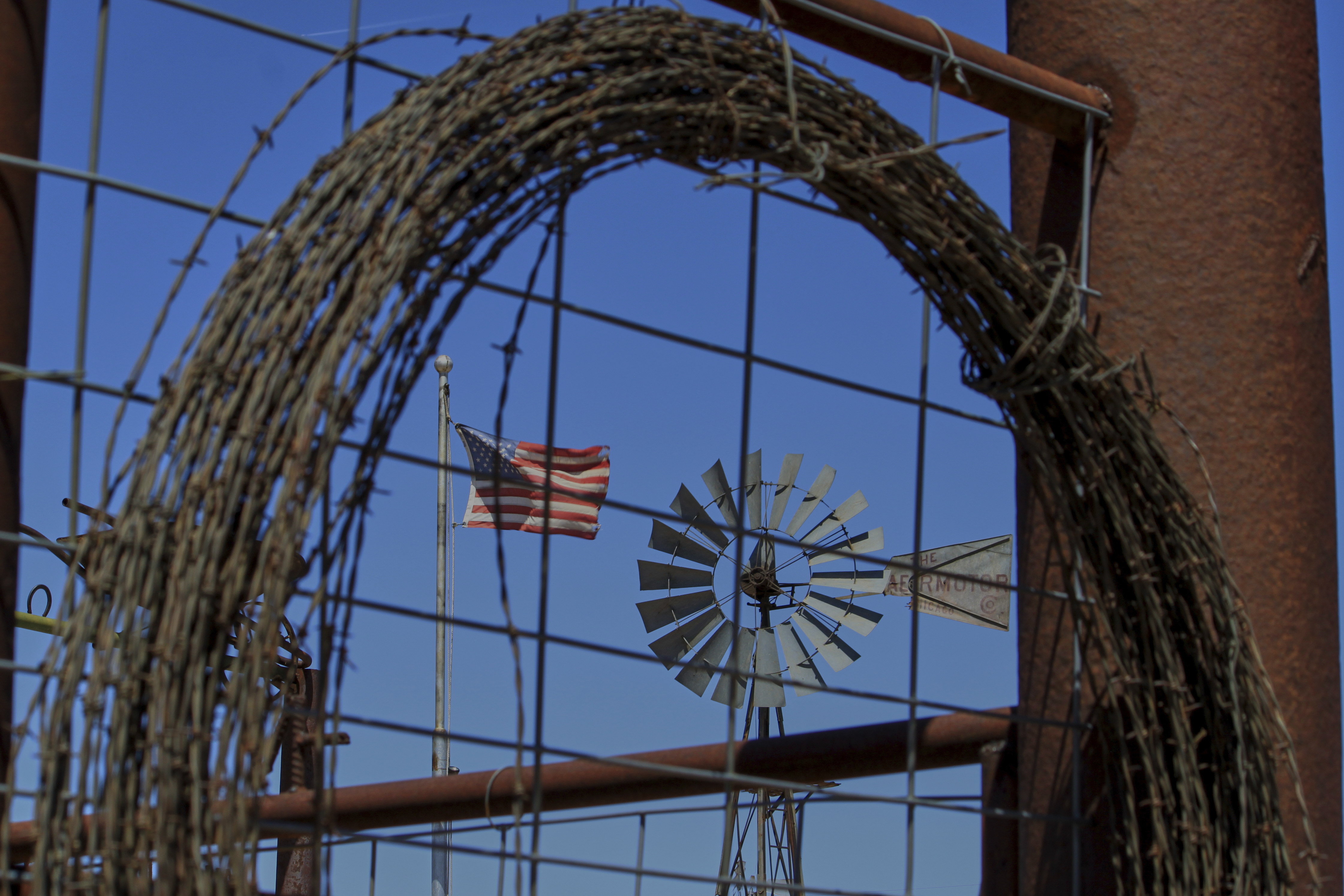 An American flag and windmill appear on display at rancher Brantley Baird's pioneer museum in Joseph City, Ariz., Wednesday, April 23, 2025. (AP Photo/Susan Montoya Bryan)