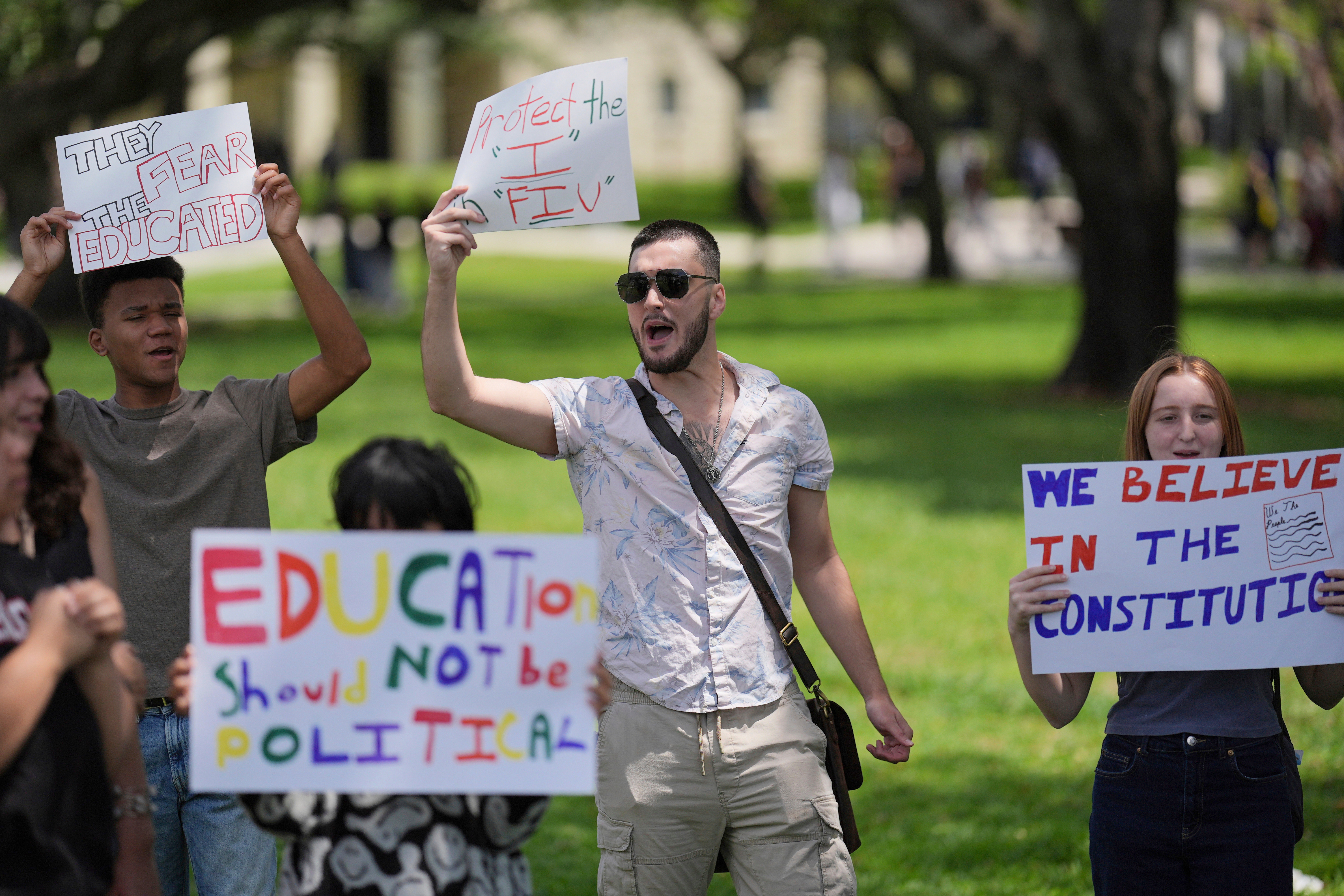 FILE - A group of Florida International University students protest against cuts in federal funding and an agreement by campus police to partner with Immigration and Customs Enforcement, on the FIU campus on a day of protests around the country in support of higher education, Thursday, April 17, 2025, in Miami. (AP Photo/Rebecca Blackwell, File)