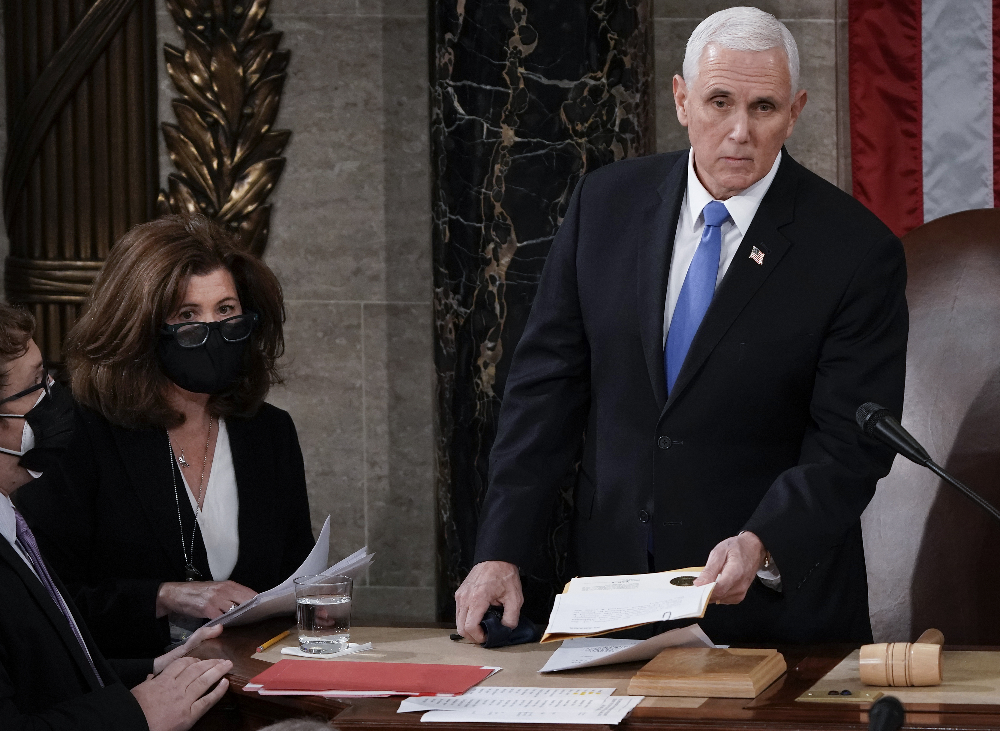 FILE - Vice President Mike Pence stands to officiate with Speaker of the House Nancy Pelosi, D-Calif., as a joint session of the House and Senate convenes to count the Electoral College votes cast in November's election, at the Capitol in Washington, Jan. 6, 2021. (AP Photo/J. Scott Applewhite, File)