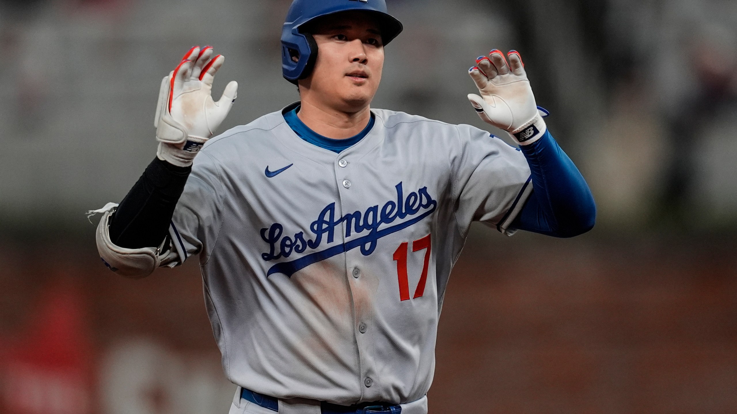 Los Angeles Dodgers two-way player Shohei Ohtani (17) celebrates his solo homer against the Atlanta Braves in the third inning of a baseball game, Saturday, May 3, 2025, in Atlanta. (AP Photo/Mike Stewart)