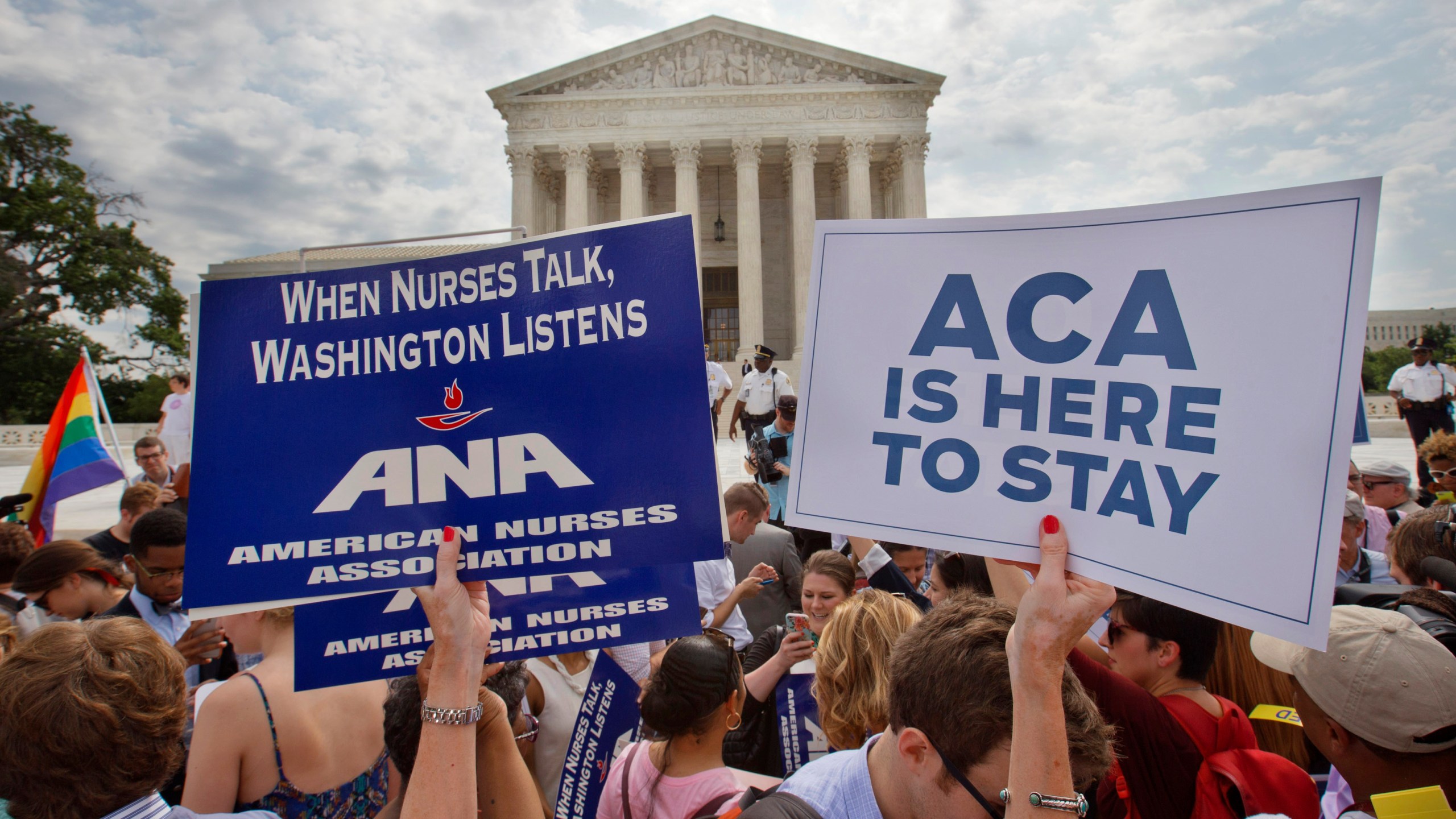 FILE - Supporters of the Affordable Care Act hold up signs as the opinion for health care is reported outside of the Supreme Court in Washington, June 25, 2015. The Supreme Court on Thursday upheld the nationwide tax subsidies under President Barack Obama's health care overhaul, in a ruling that preserves health insurance for millions of Americans. (AP Photo/Jacquelyn Martin, File)