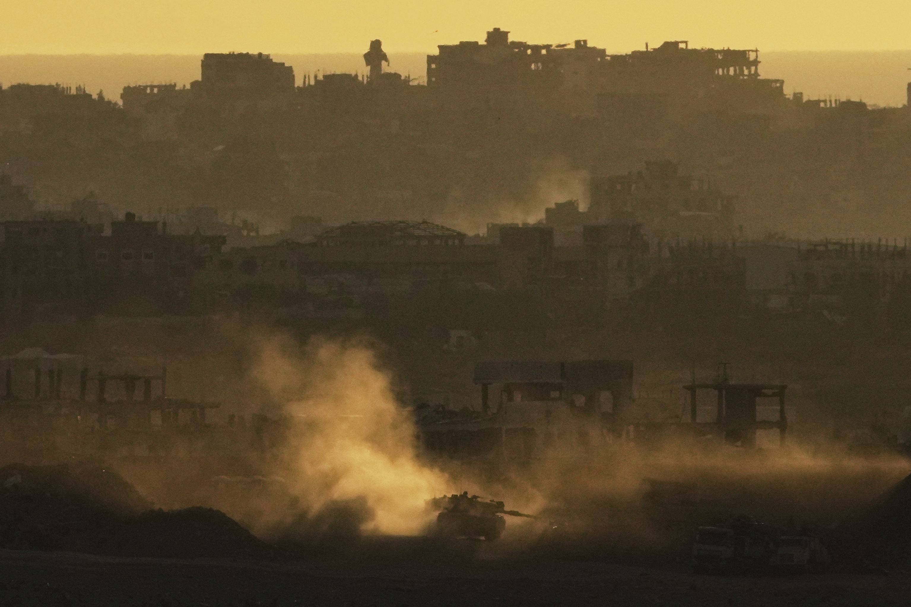An Israeli army tank maneuvers in the Gaza Strip is seen from southern Israel, Sunday, May 4, 2025. (AP Photo/Ariel Schalit)