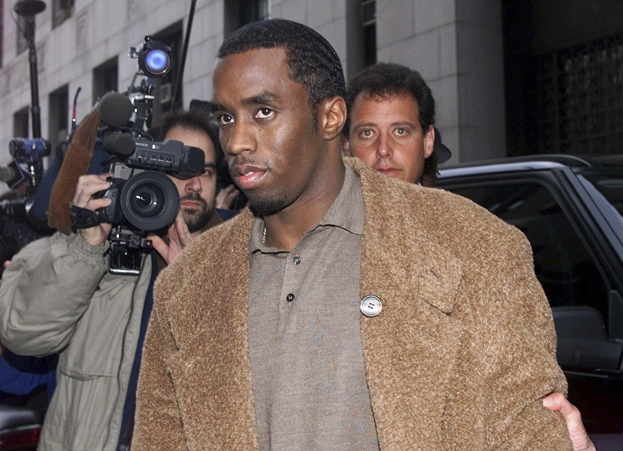 FILE - Rapper Sean "Puffy" Combs arrives at the Manhattan District Attorney's office in New York, on Jan. 4, 2000, where Combs and his girlfriend Jennifer Lopez were to appear before a grand jury investigating the Times Square nightclub shooting that left three people injured in late Dec. 1999. (AP Photo/Kathy Willens, File)
