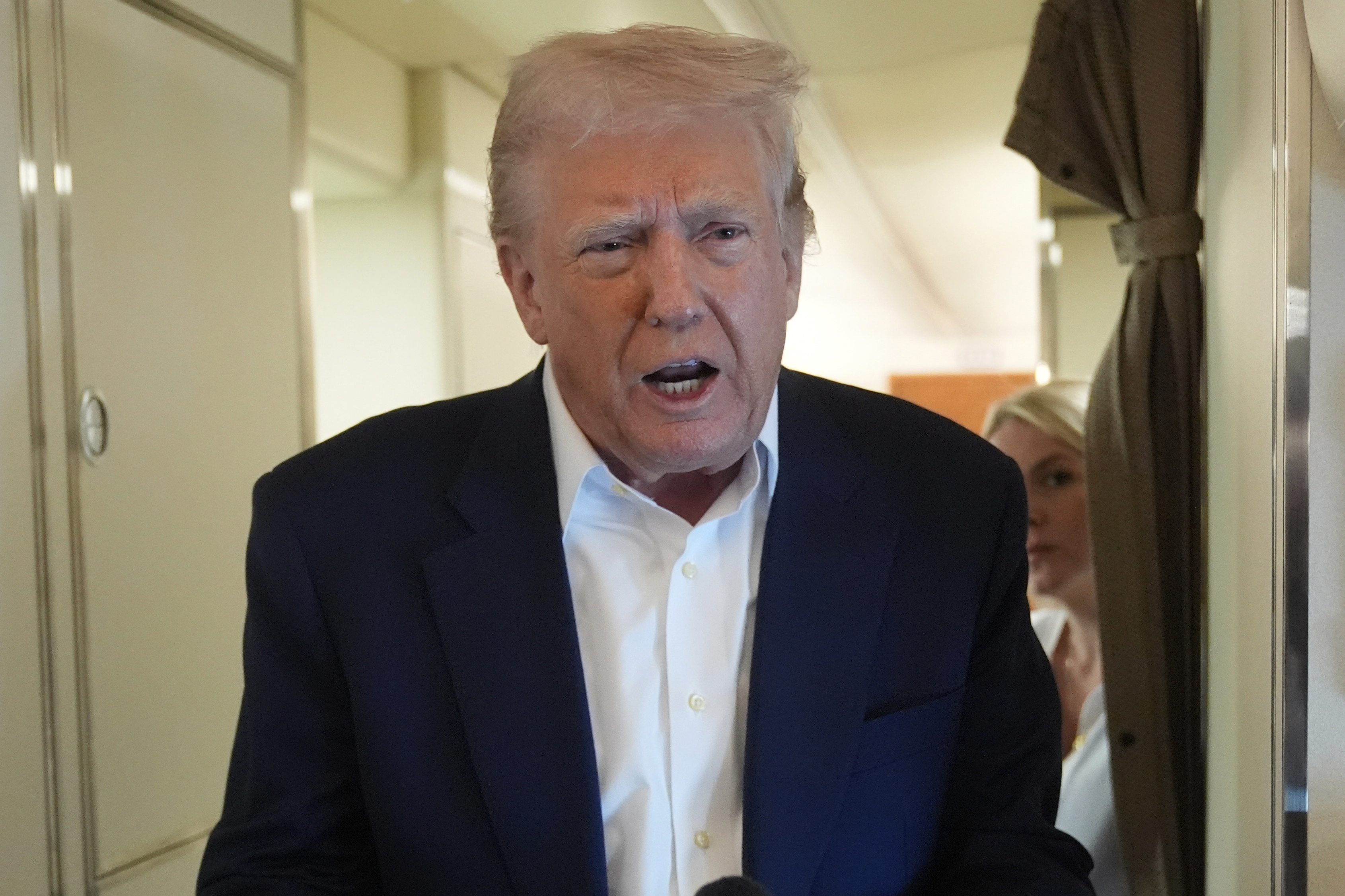 President Donald Trump talks with reporters on Air Force One as he heads back to Washington, Sunday, May 4, 2025, from West Palm Beach, Fla. (AP Photo/Manuel Balce Ceneta)