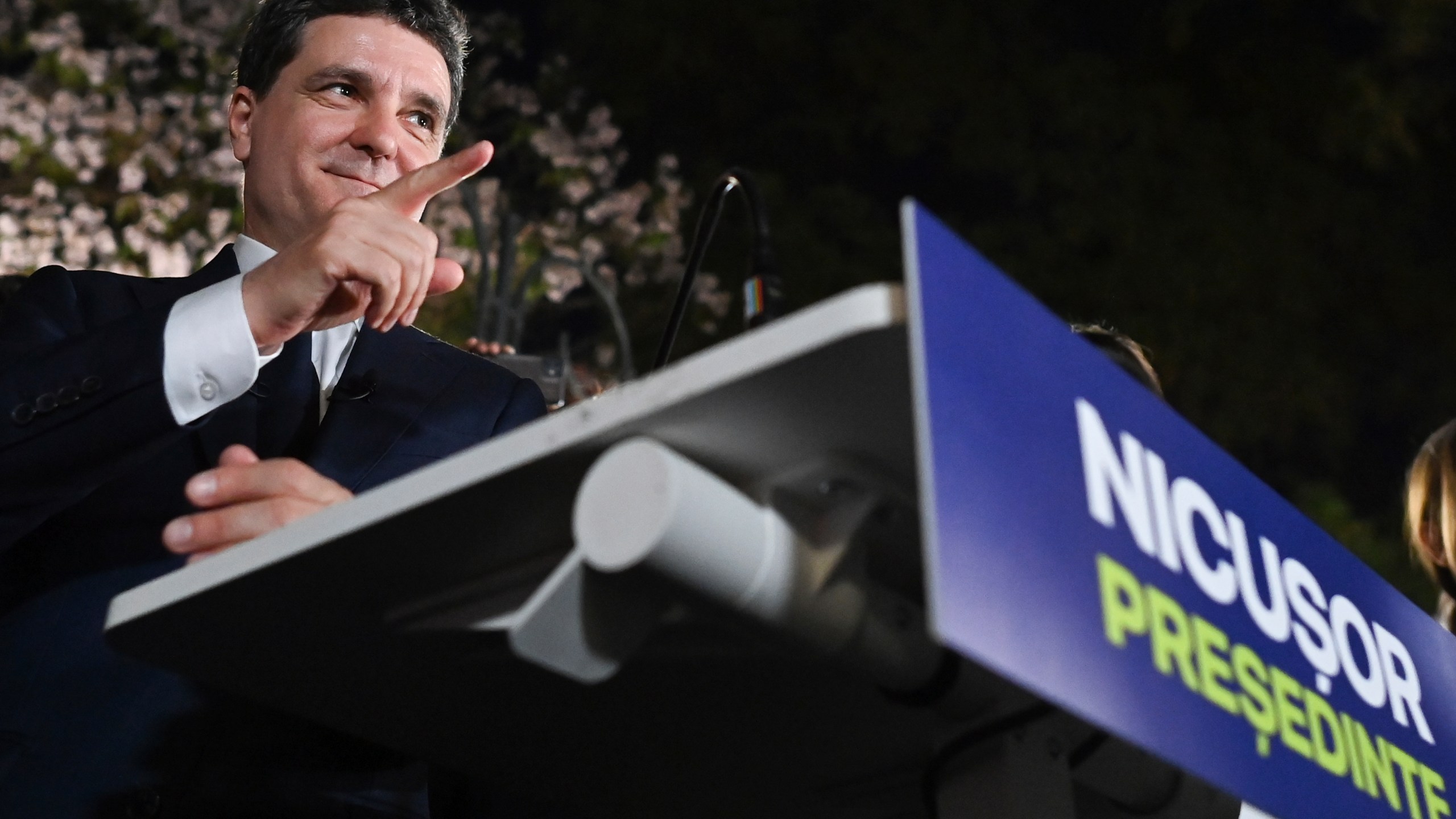Presidential candidate Nicusor Dan gestures as he addresses supporters after polls closed for the first round of the country's presidential election redo in Bucharest, Romania, Sunday, May 4, 2025. (AP Photo/Eduard Vinatoru)