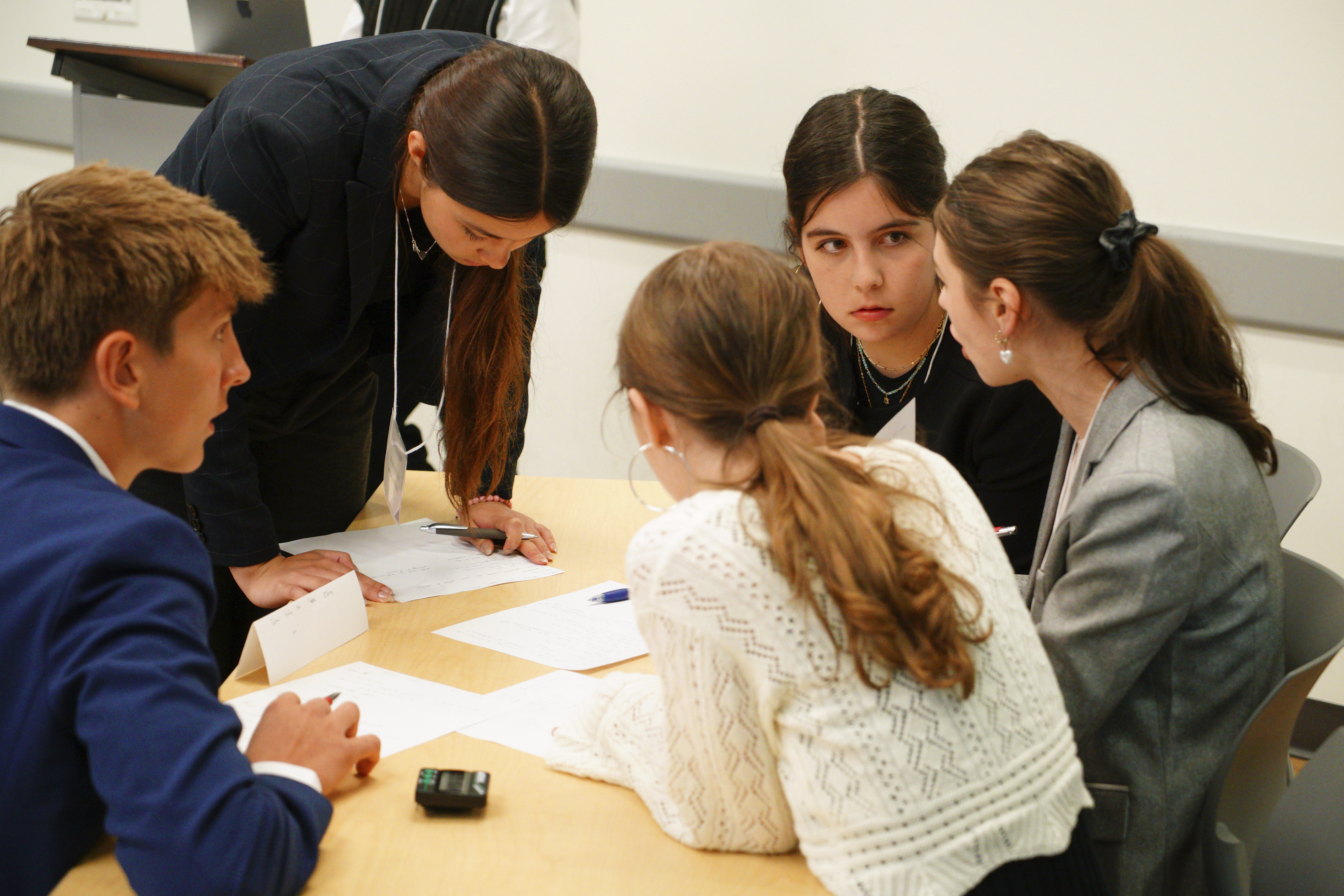 Kate Kruger, facing camera, and other students from Atlanta's Midtown High School confer during a semifinal round of the National High School Ethics Bowl in Chapel Hill, N.C., on Sunday, April 13, 2025. (AP Photo/Allen G. Breed)