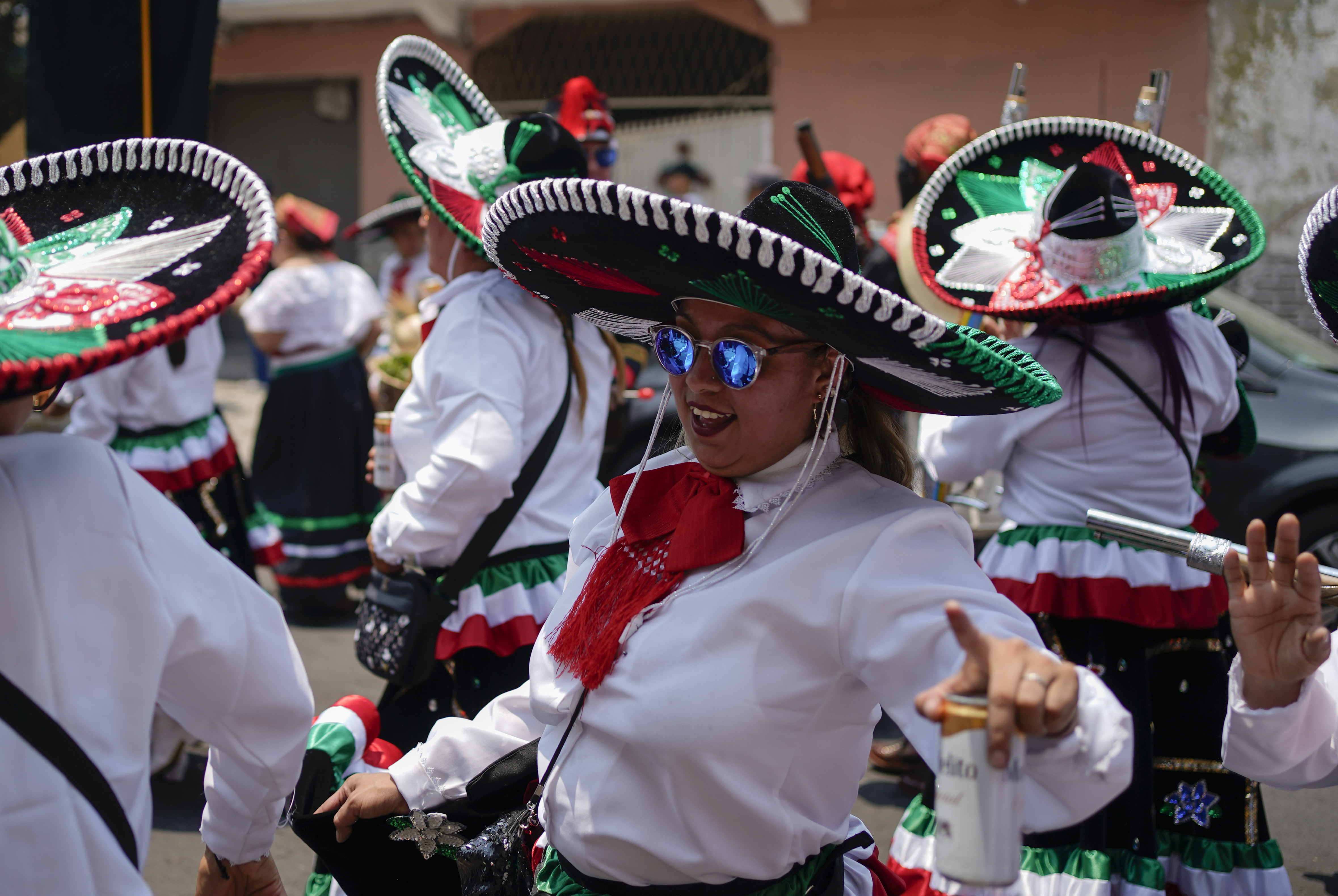 FILE - Women dance during a re-enactment of The Battle of Puebla as part of Cinco de Mayo celebrations in the Peñon de los Baños neighborhood of Mexico City, May 5, 2022. (AP Photo/Eduardo Verdugo, File)