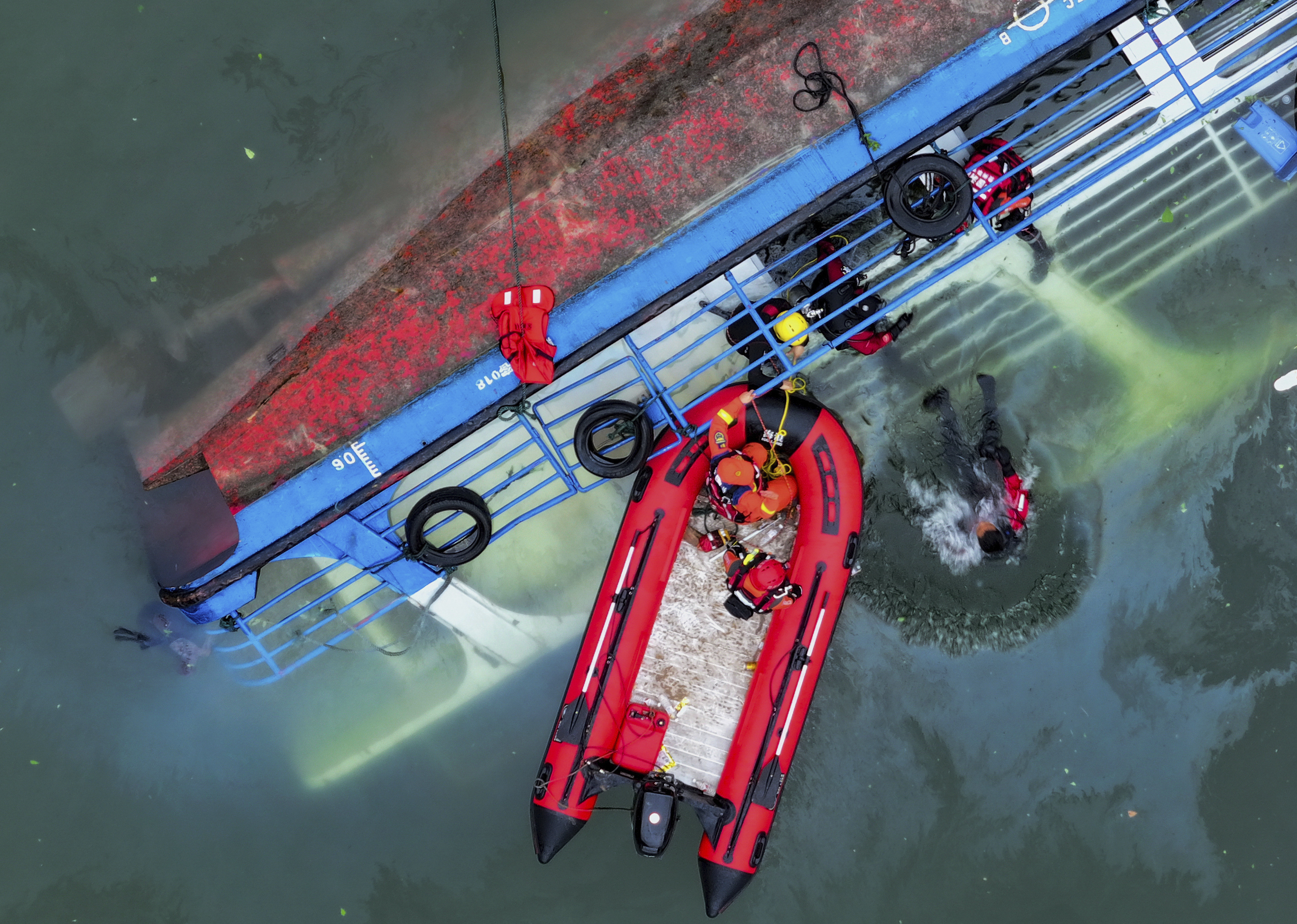 In this photo released by Xinhua News Agency, rescuers conduct a search and rescue operation at one of the two passenger boats capsized in Qianxi City, southwest China's Guizhou Province on Monday, May 5, 2025. (Liu Xu/Xinhua via AP)