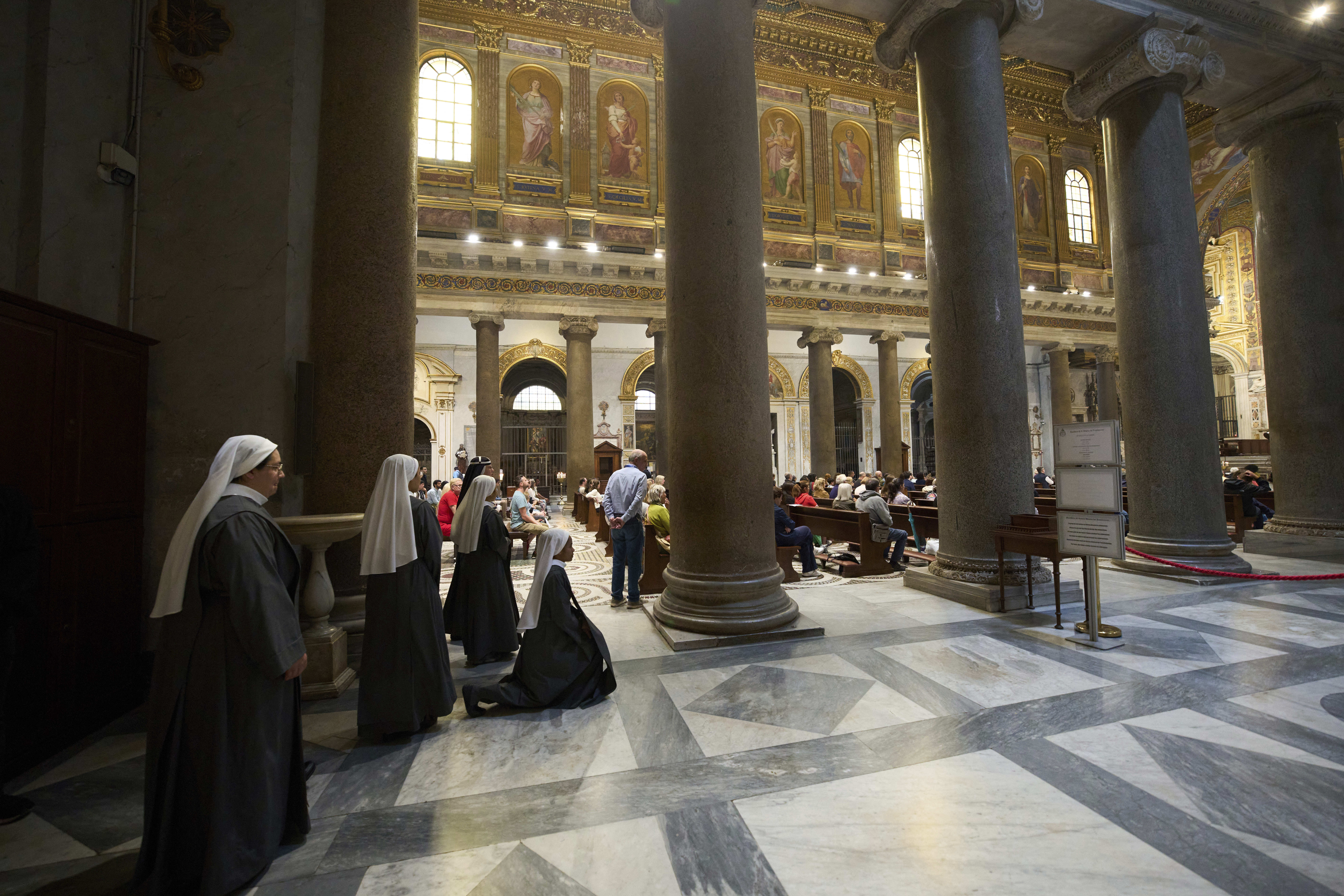 Nuns prays during a mass in Santa Maria in Trastevere church, in central Rome, Sunday, May 4, 2025. (AP Photo/Alessandra Tarantino)