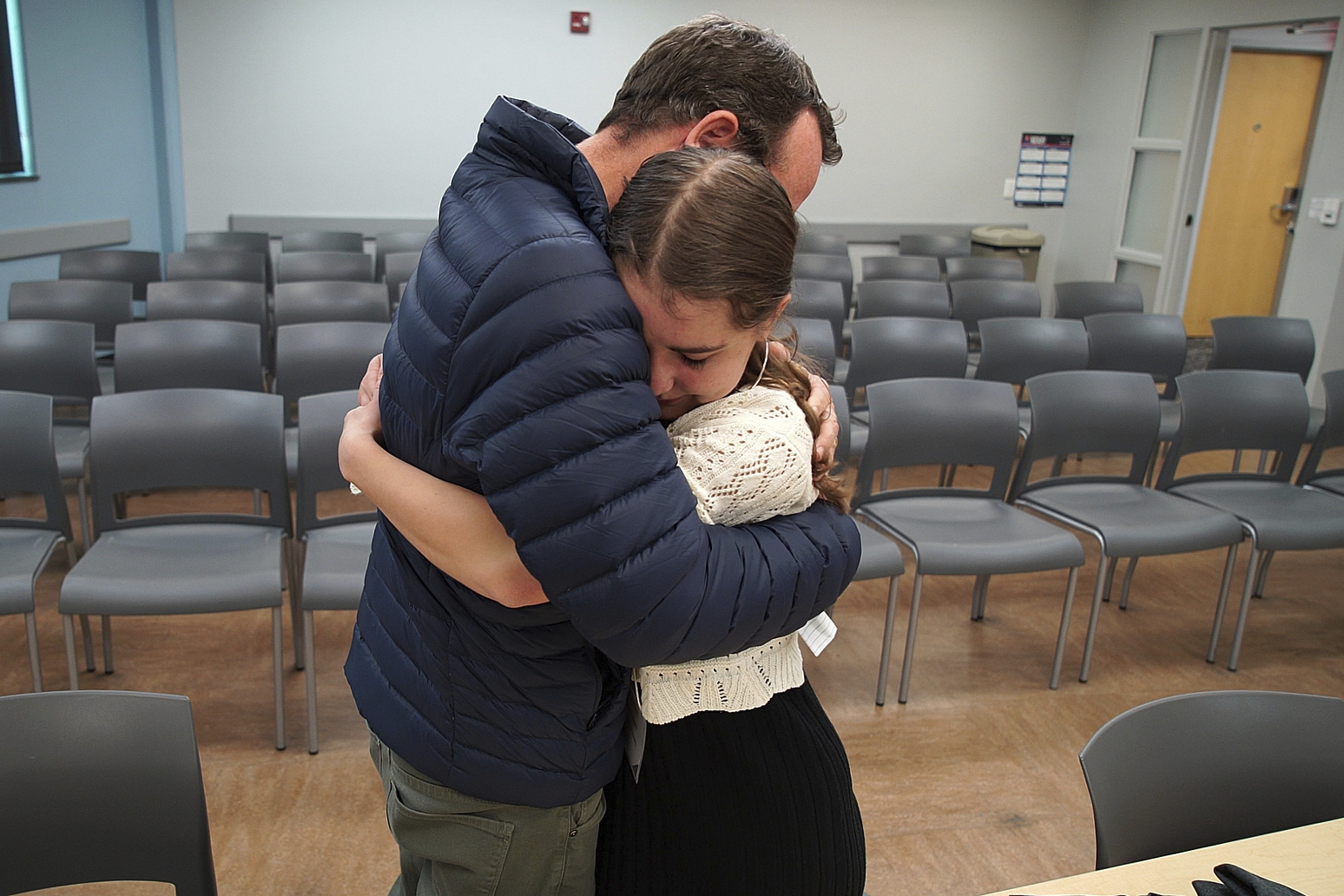 In this image taken from video, Kevin Lyman comforts his daughter, Lizzie, after her team from Atlanta's Midtown High School lost in the semifinals of the National High School Ethics Bowl, Sunday, April 23, 2025, in Chapel Hill, N.C. (AP Photo/Allen G. Breed)