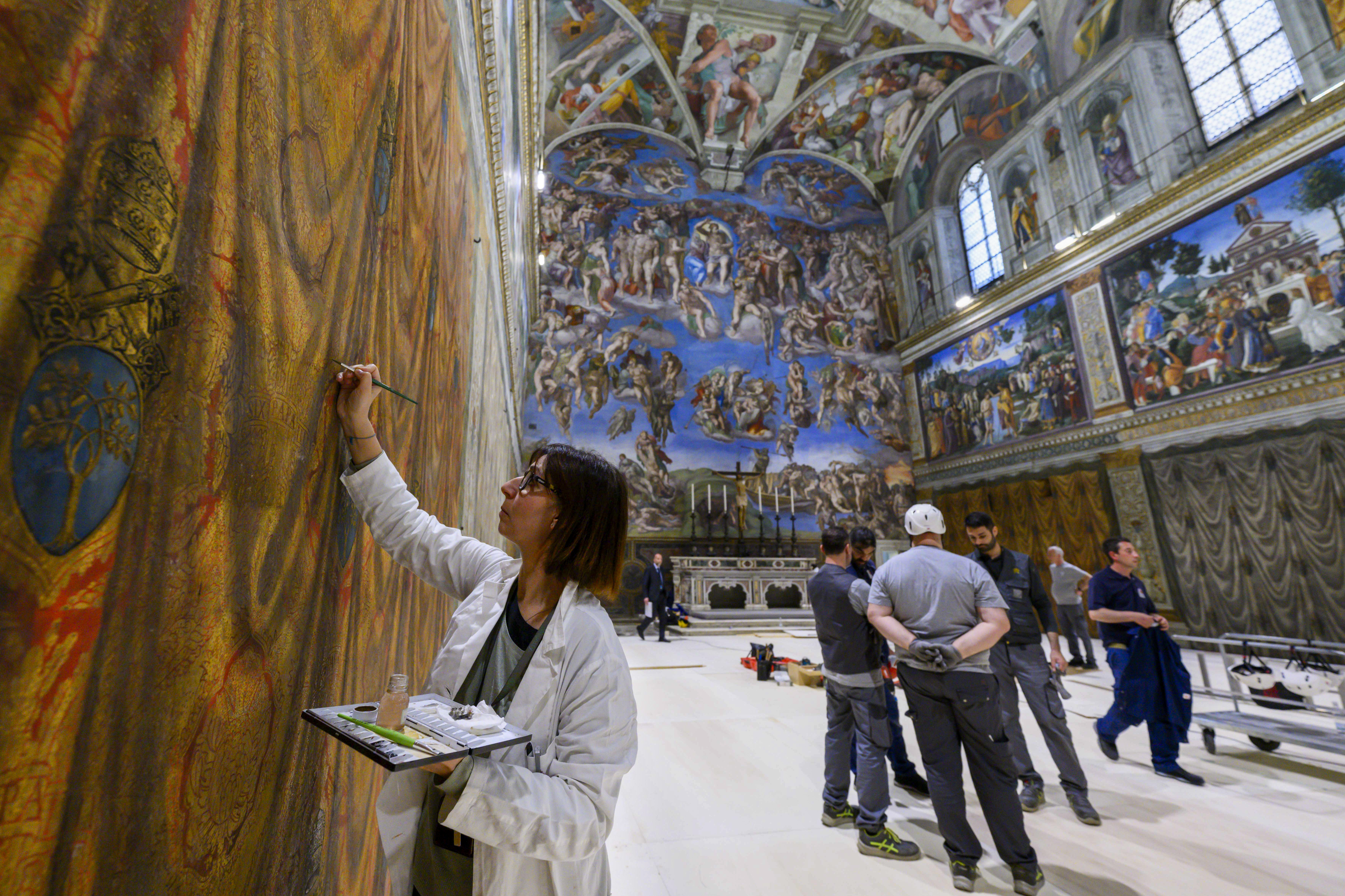 In this image taken on Wednesday, April 30, 2025, and made available Saturday, May 3, 2025, by Vatican Media, workers and restorers prepare the Sistine Chapel at the Vatican, where the upcoming conclave will start May 7. (Vatican Media via AP)