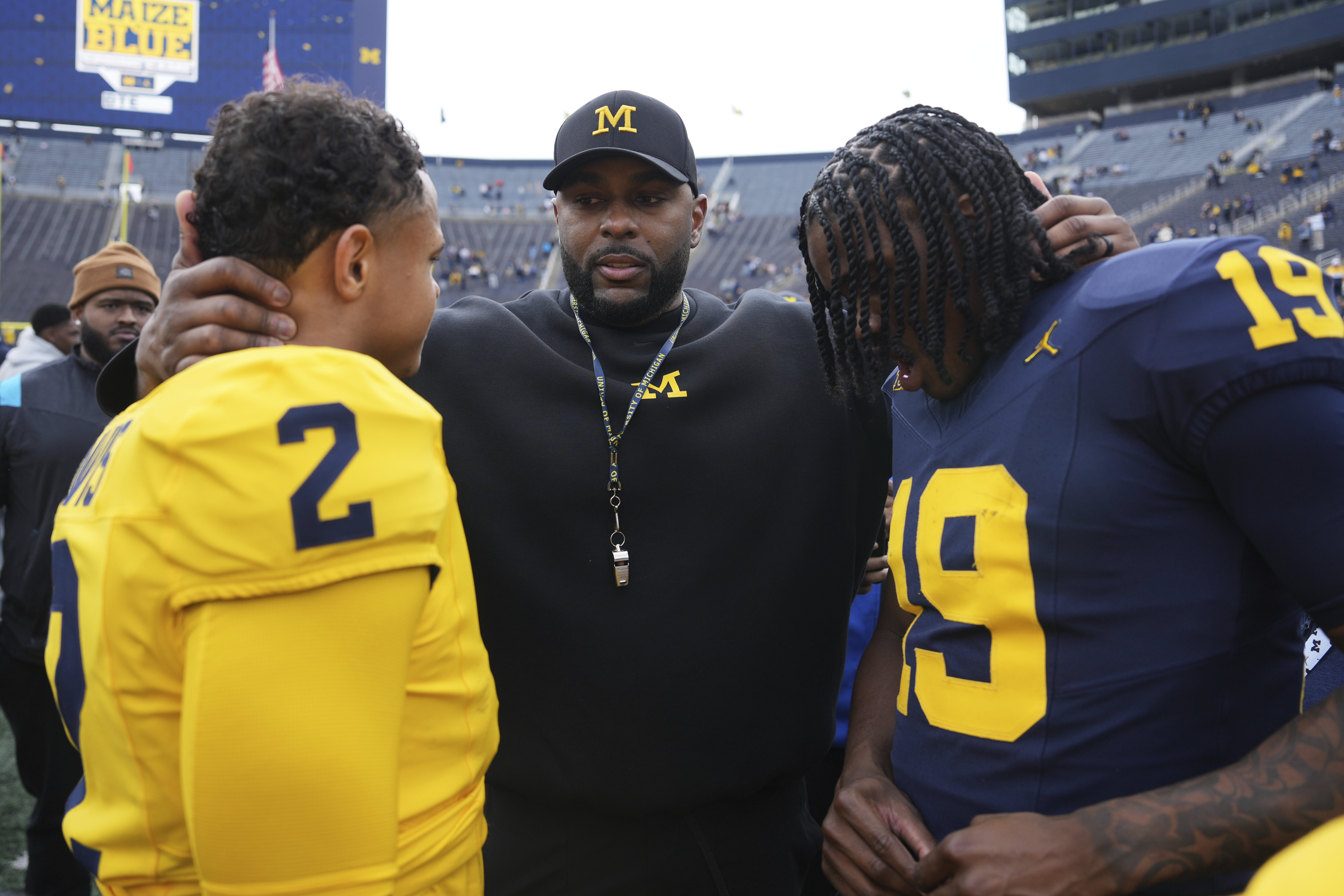 Michigan head coach Sherrone Moore, center, talks with quarterbacks Jadyn Davis (2) and Bryce Underwood (19) after an NCAA college football spring game in Ann Arbor, Mich., Saturday, April 19, 2025. (AP Photo/Paul Sancya)