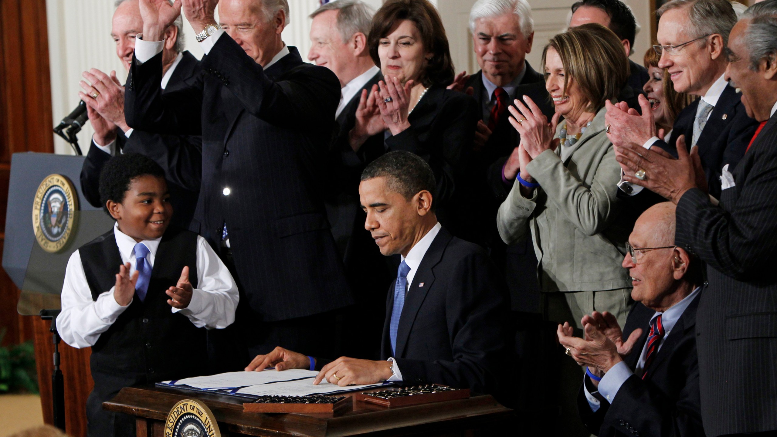 FILE - President Barack Obama is applauded after signing the Affordable Care Act into law in the East Room of the White House in Washington, March 23, 2010. (AP Photo/Charles Dharapak, File)