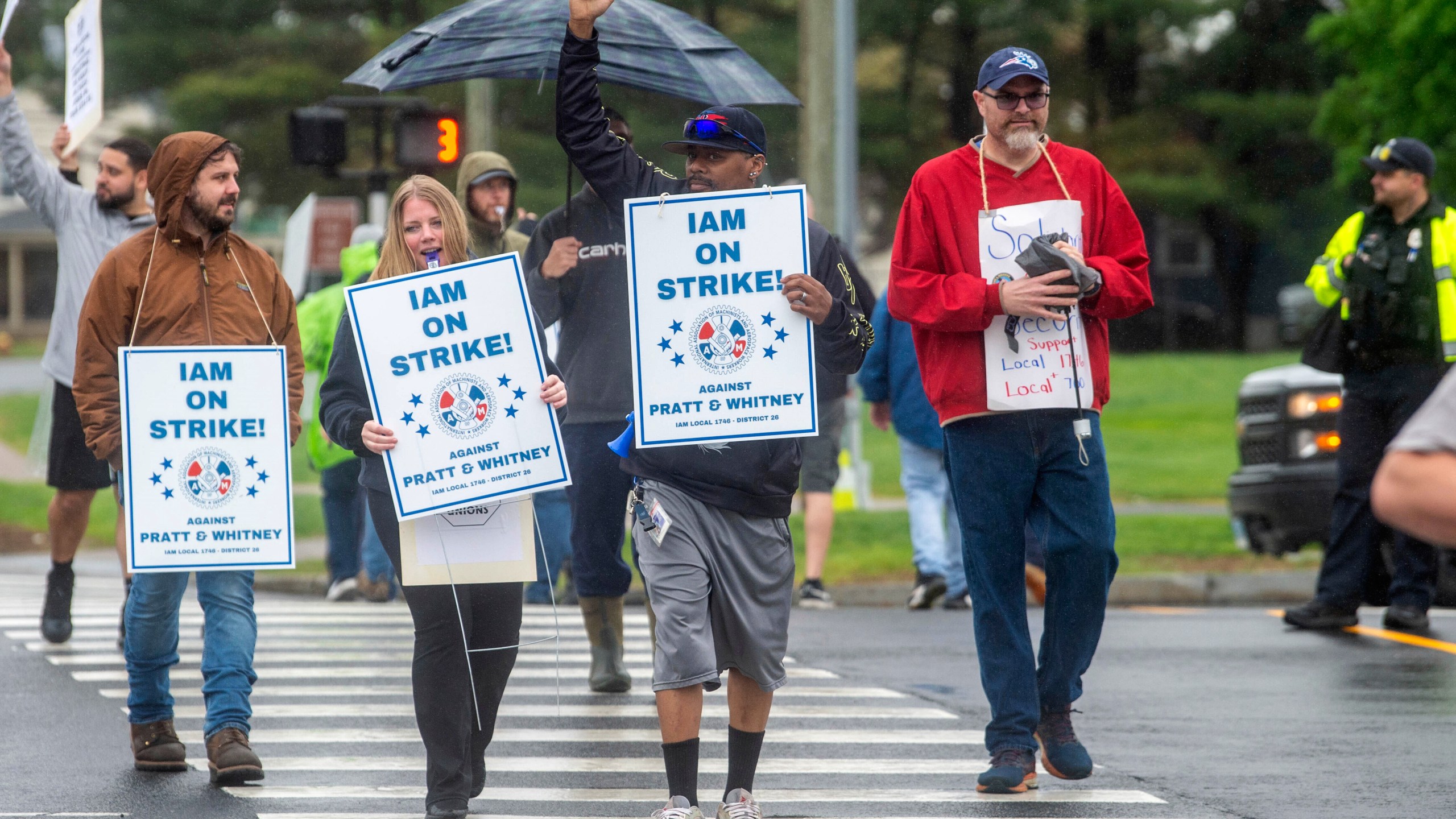Pratt & Whitney employees hold signs while picketing at the Silver Lane entrance in East Hartford, Conn., on the first day of their strike, Monday, May 5, 2025. (Aaron Flaum/Hartford Courant via AP)