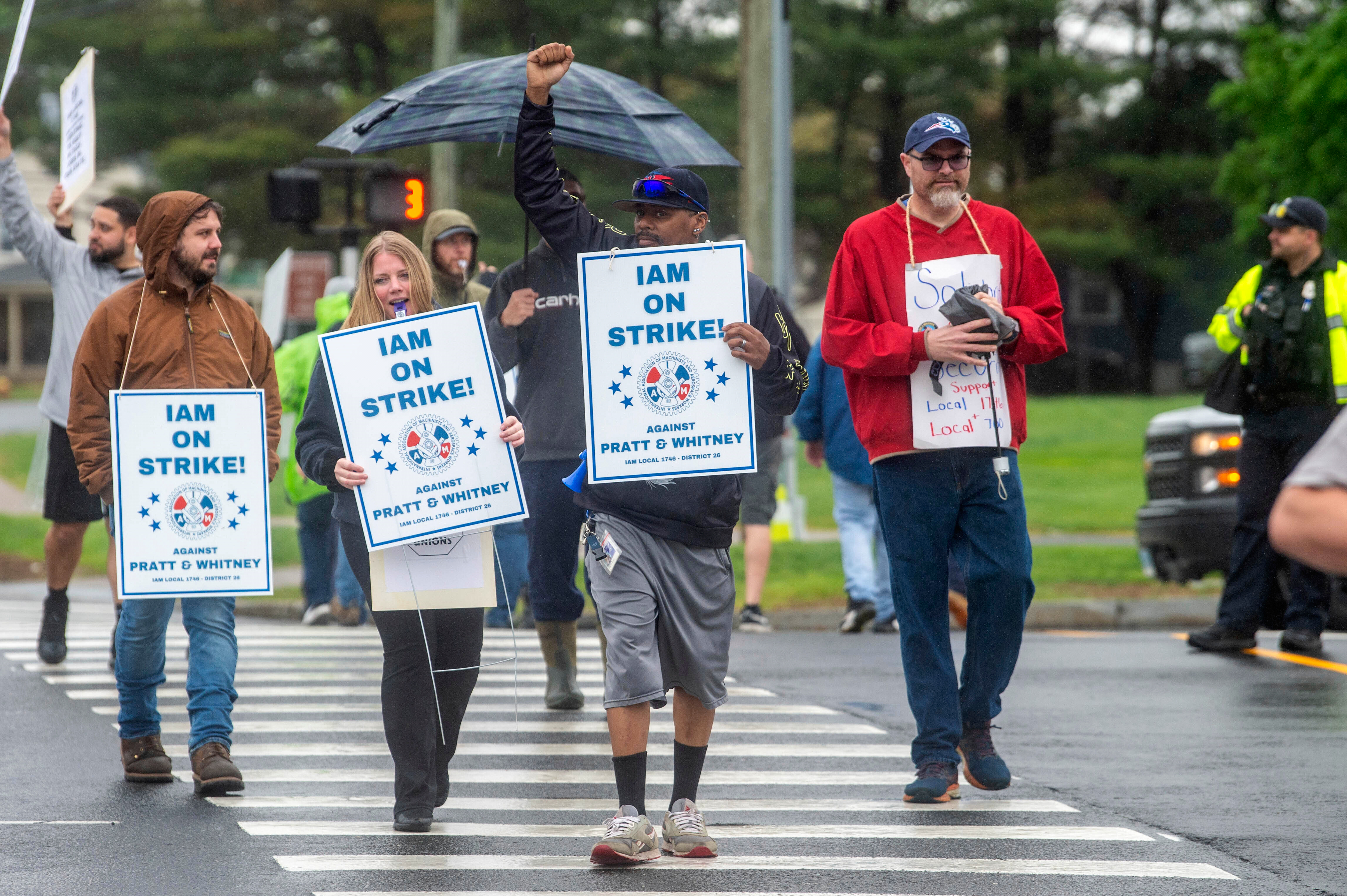 Pratt & Whitney employees hold signs while picketing at the Silver Lane entrance in East Hartford, Conn., on the first day of their strike, Monday, May 5, 2025. (Aaron Flaum/Hartford Courant via AP)