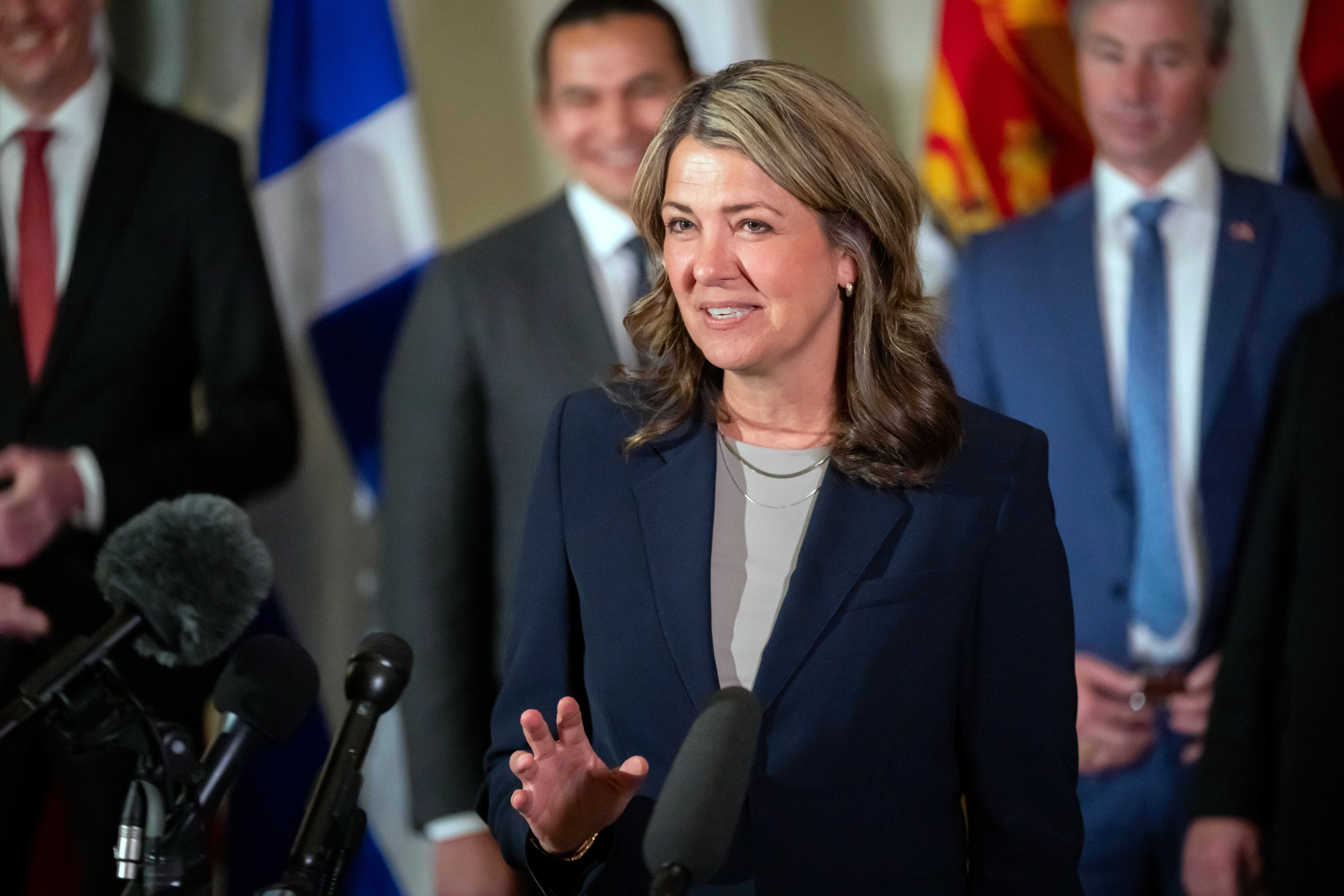 FILE - Premier of Alberta Danielle Smith, accompanied by other Council of the Federation members, speaks to reporters at the Mayflower Hotel in Washington, Feb. 12, 2025. (AP Photo/Ben Curtis, File)