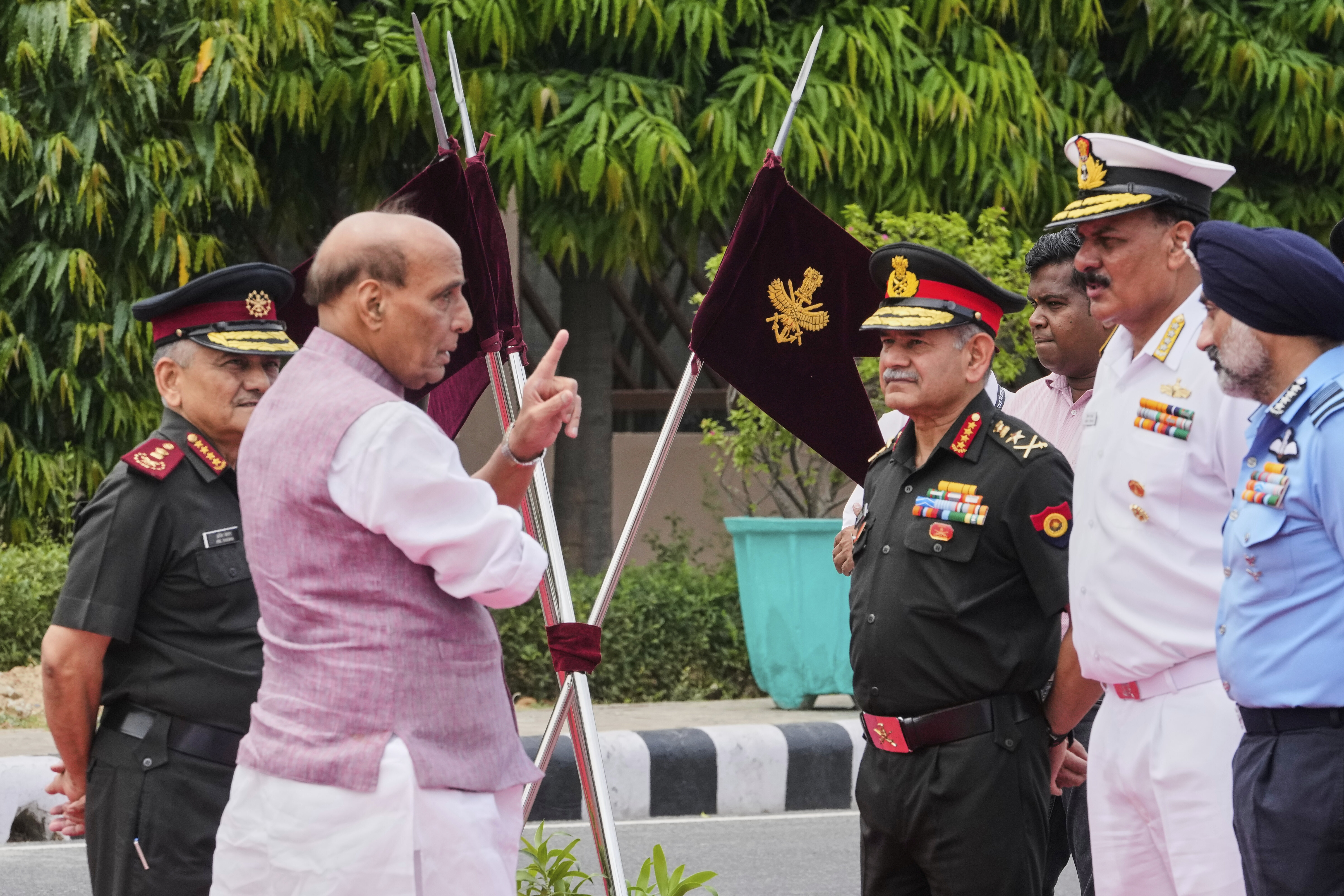 Indian Defense Minister Rajnath Singh, second left, talks to three Indian defense chiefs, Army General Upendra Dwivedi, third right, Naval Admiral Dinesh K Tripathi, second right, and Air Force Air Chief Marshal A P Singh, right, as Indian Chief of Defense Staff General Anil Chauhan, left, watches as they wait for the arrival of Japan's Defense Minister Gen Nakatani in New Delhi, India, Monday, May 5, 2025.(AP Photo/Manish Swarup)