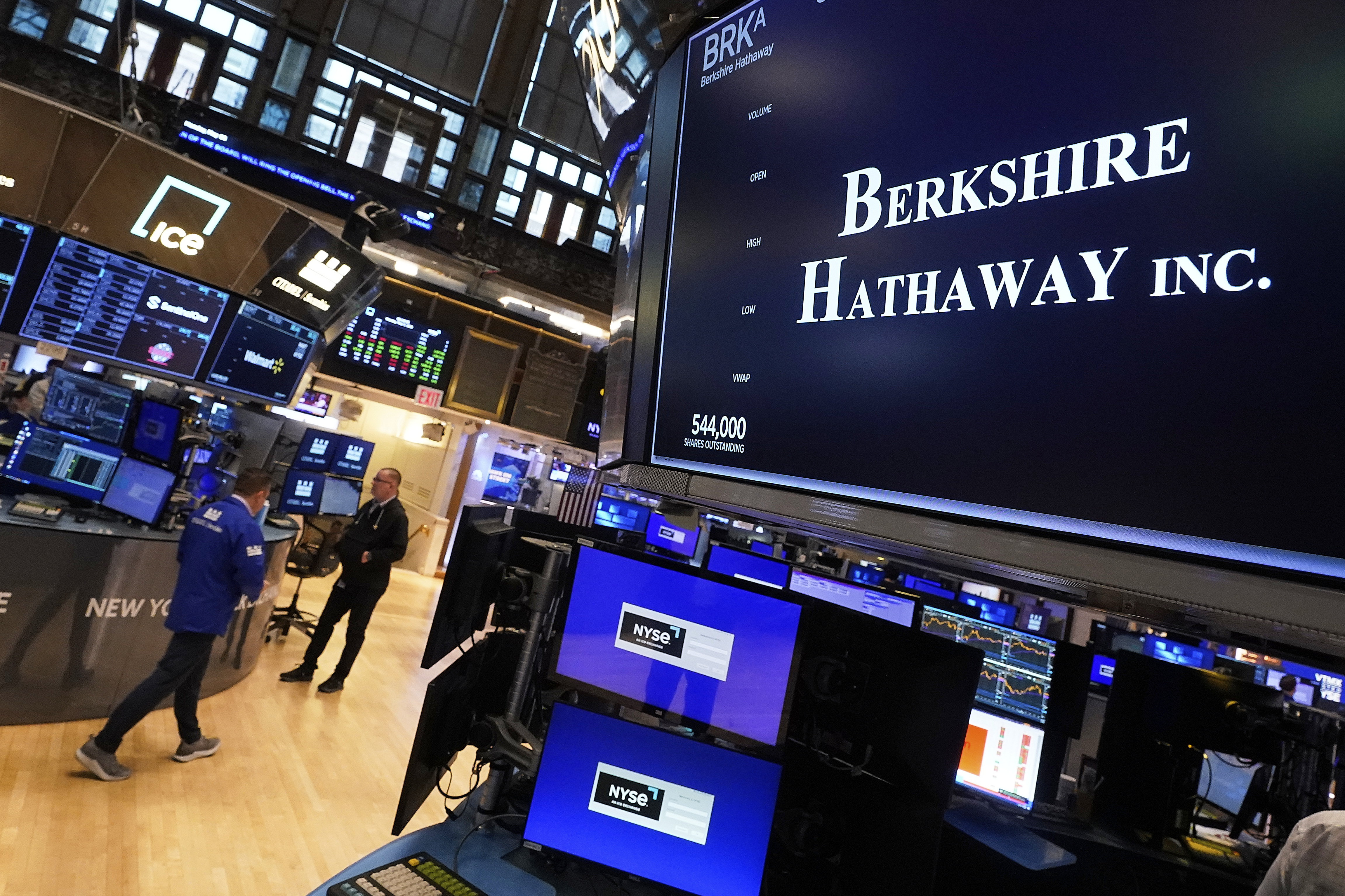 The logo for Berkshire Hathaway Inc. appears above a trading post on the floor of the New York Stock Exchange, Monday, May 5, 2025. (AP Photo/Richard Drew)