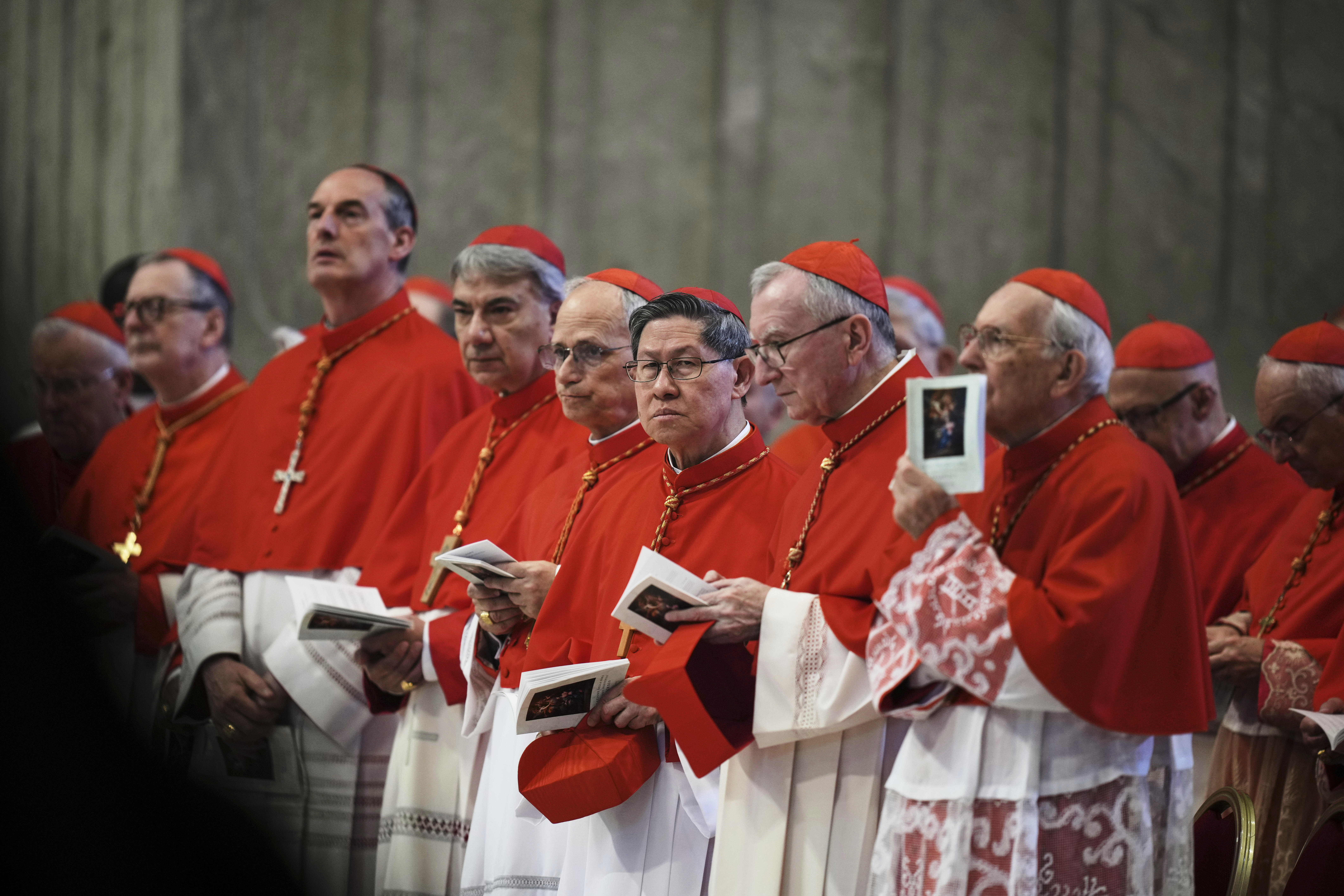 FILE - Cardinal Luis Antonio Tagle, center, takes part in the procession carrying the body of Pope Francis to St. Peter's Basilica at the Vatican, Wednesday, April 23, 2025, where he will lie in state for three days. (AP Photo/Alessandra Tarantino, File)