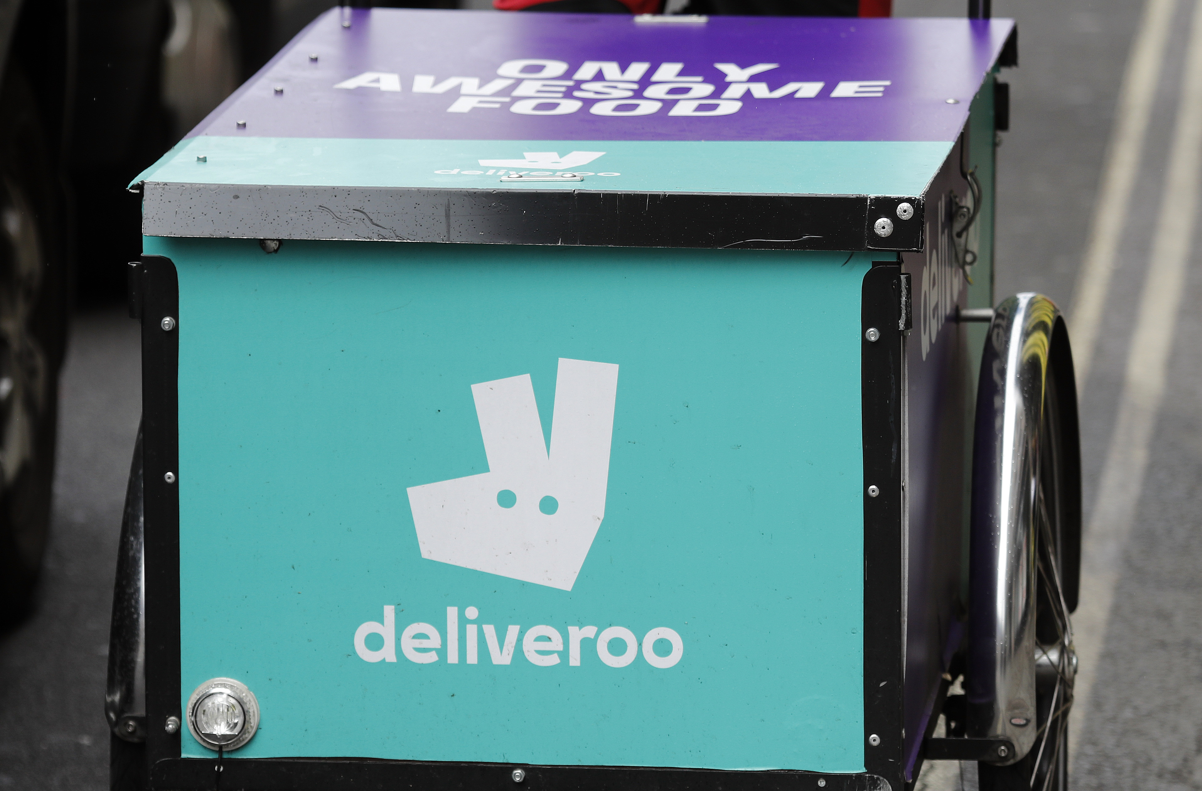 FILE - This July 11, 2017 file photo, shows a deliveroo logo on a bicycle in London. (AP Photo/Frank Augstein, File)