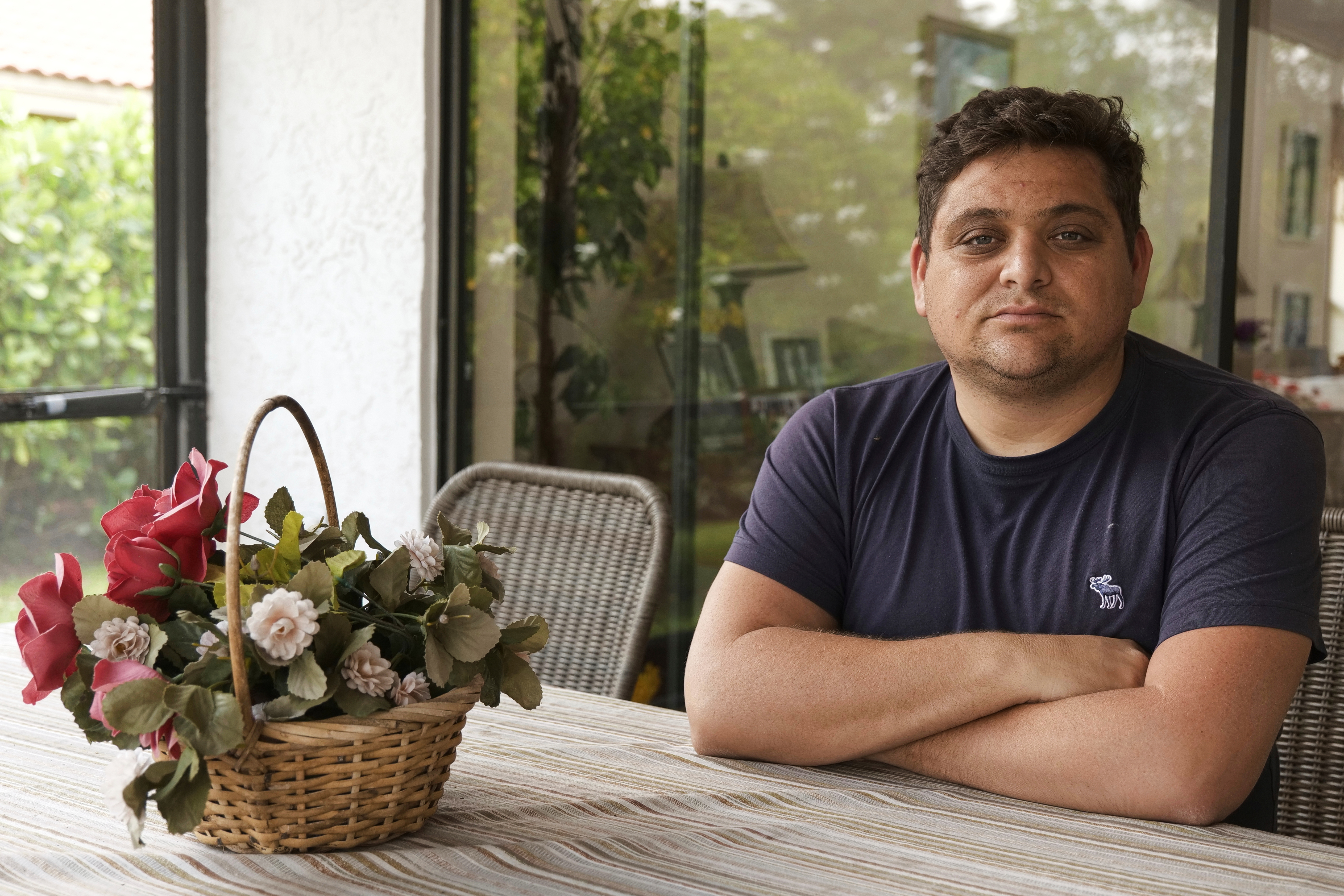 Spencer Goidel, an Equal Employment Opportunity Specialist with the Internal Revenue Service who was notified his job would be eliminated as part of the government's efficiency cuts, poses for a portrait at his home in Boca Raton, Fla., April 16, 2025. (AP Photo/Daniel Kozin)