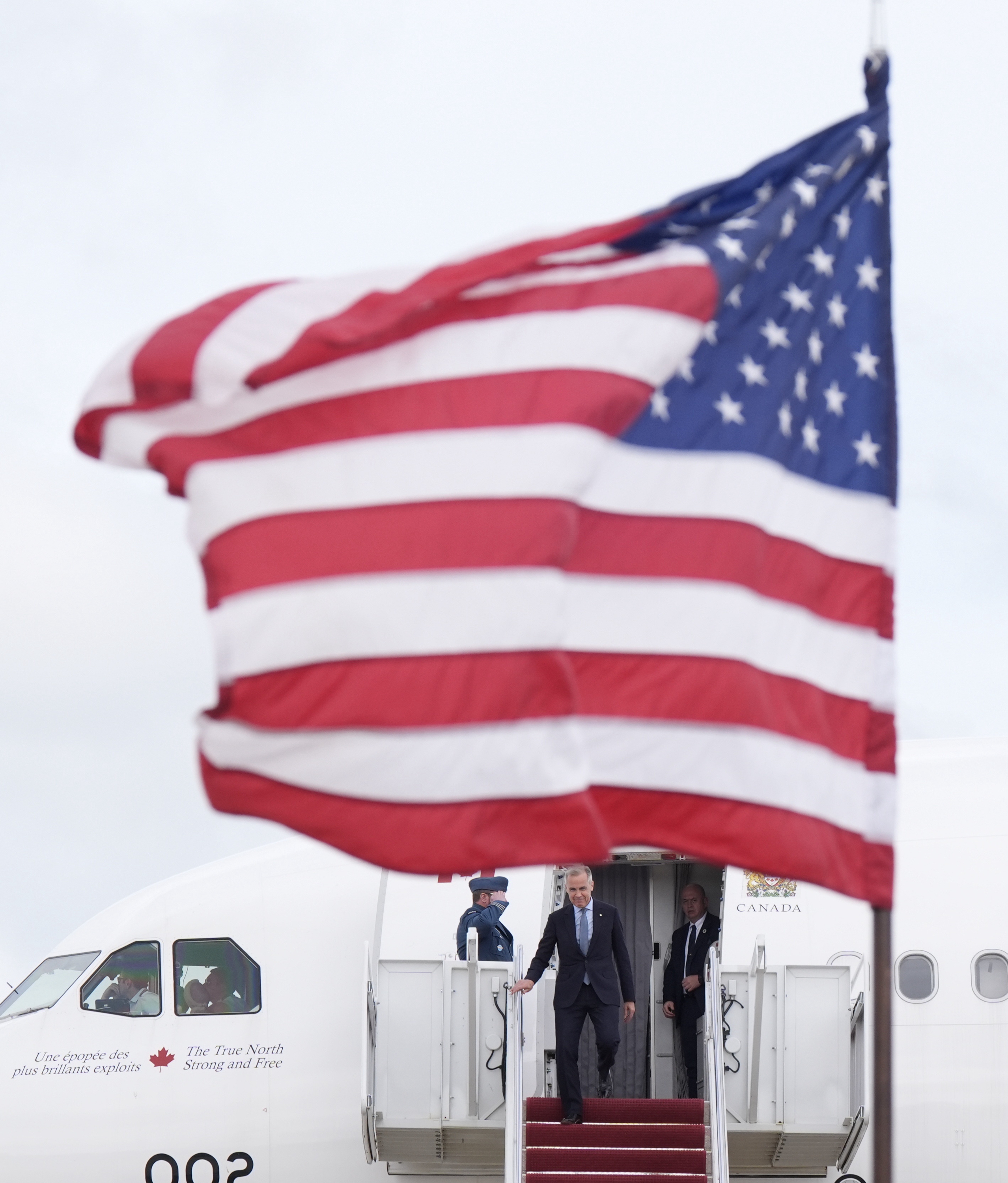 Canada's Prime Minister Mark Carney disembarks a government plane Monday May 5, 2025, as he arrives in Washington, to meet with President Donald Trump. (Adrian Wyld/The Canadian Press via AP)