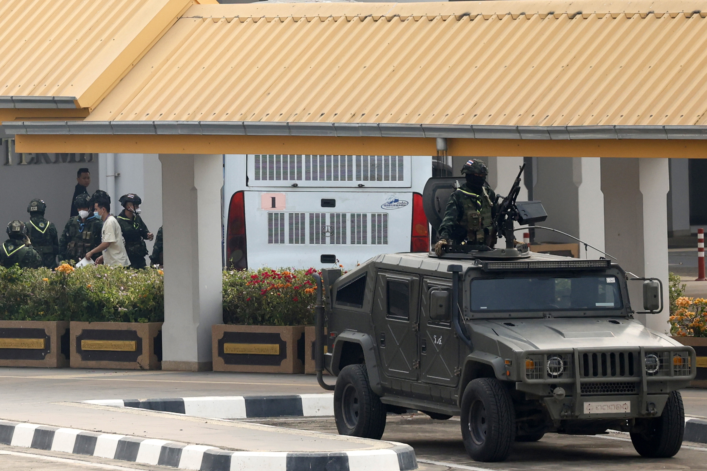 FILE - Thai soldiers provide security for the transfer of Chinese nationals who had worked at scam centers in eastern Myanmar, on their arrival at Thailand's Mae Sot International Airport, Tak province before being sent back to China on Thursday, Feb. 20, 2025. (AP Photo/Sarot Meksophawannakul, File)