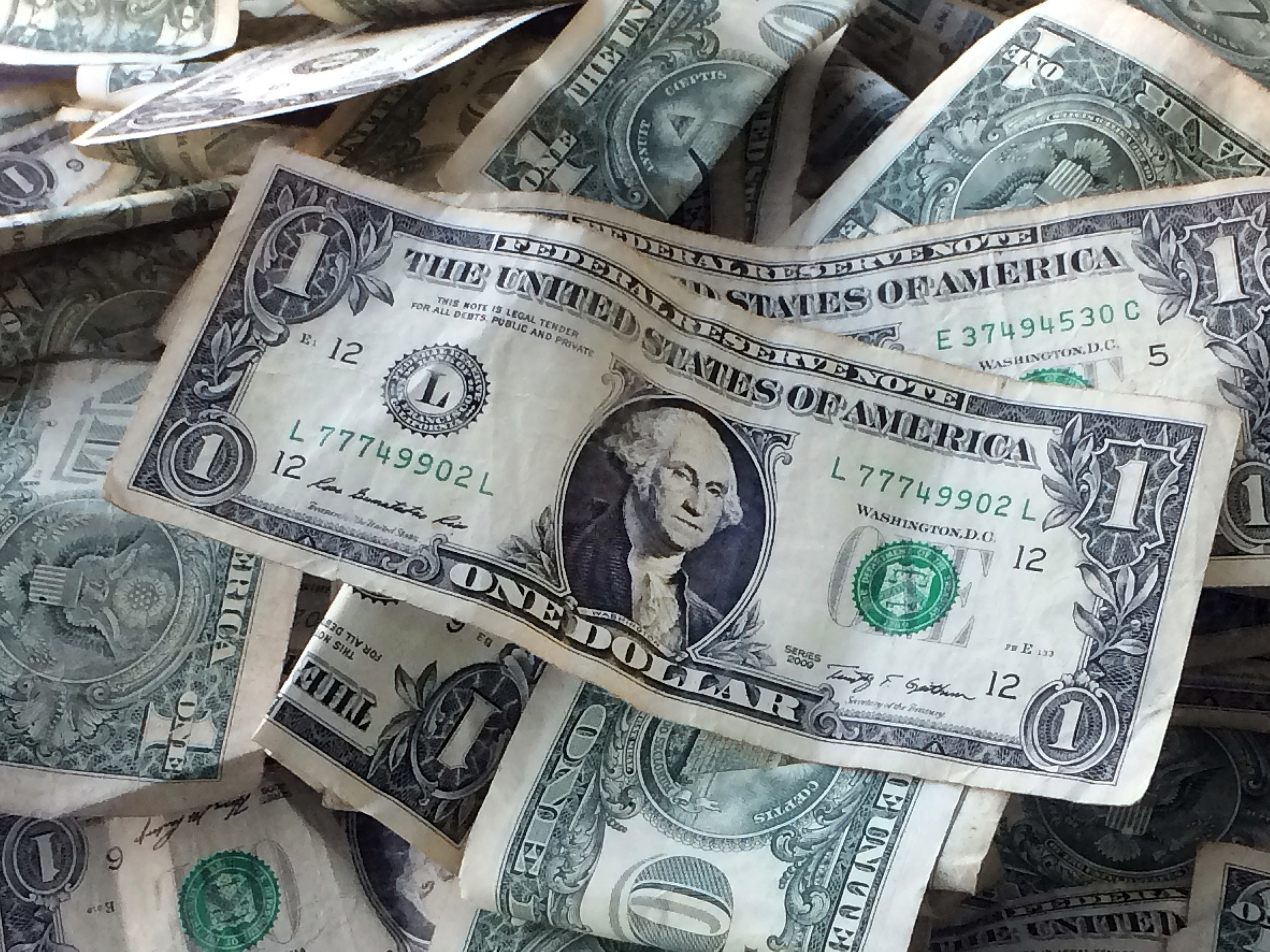 FILE - This Oct. 24, 2016 file photo shows dollar bills in New York. (AP Photo/Mark Lennihan, File)