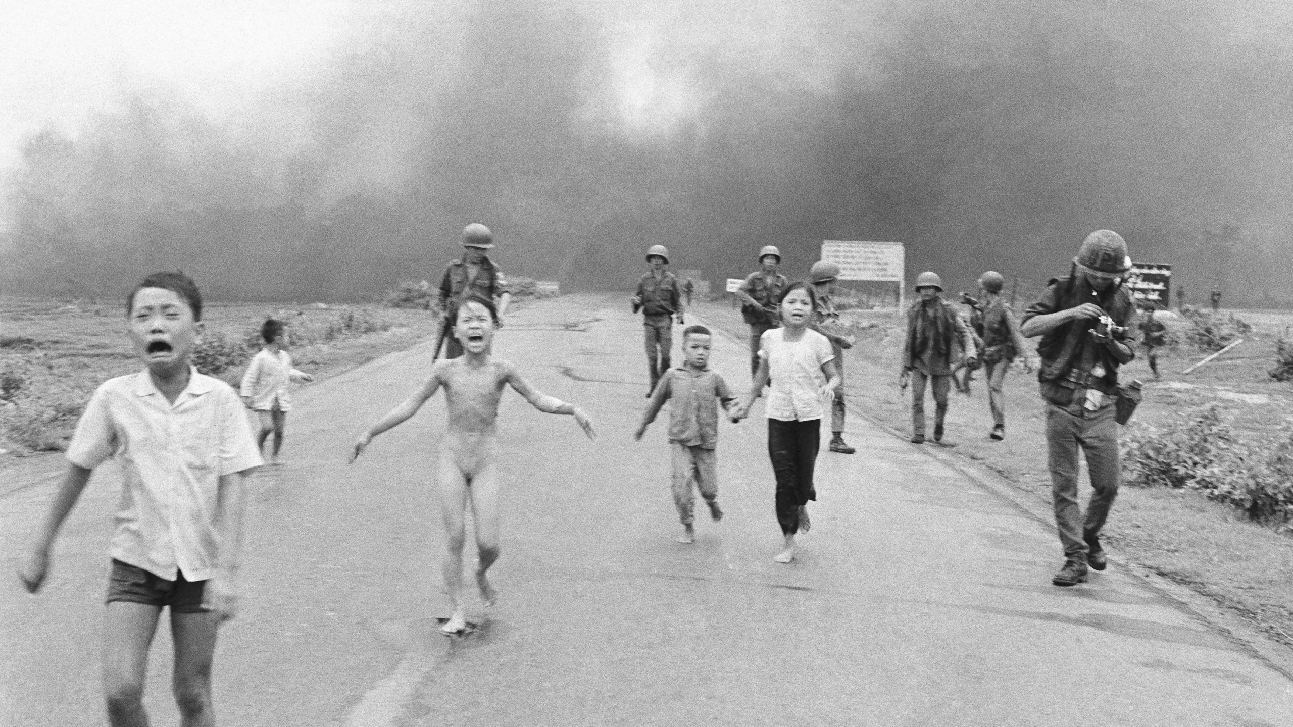 FILE - South Vietnamese forces follow after terrified children, including 9-year-old Kim Phuc, center, as they run down Route 1 near Trang Bang after an aerial napalm attack on suspected Viet Cong hiding places, June 8, 1972. (AP Photo/Nick Ut, File)