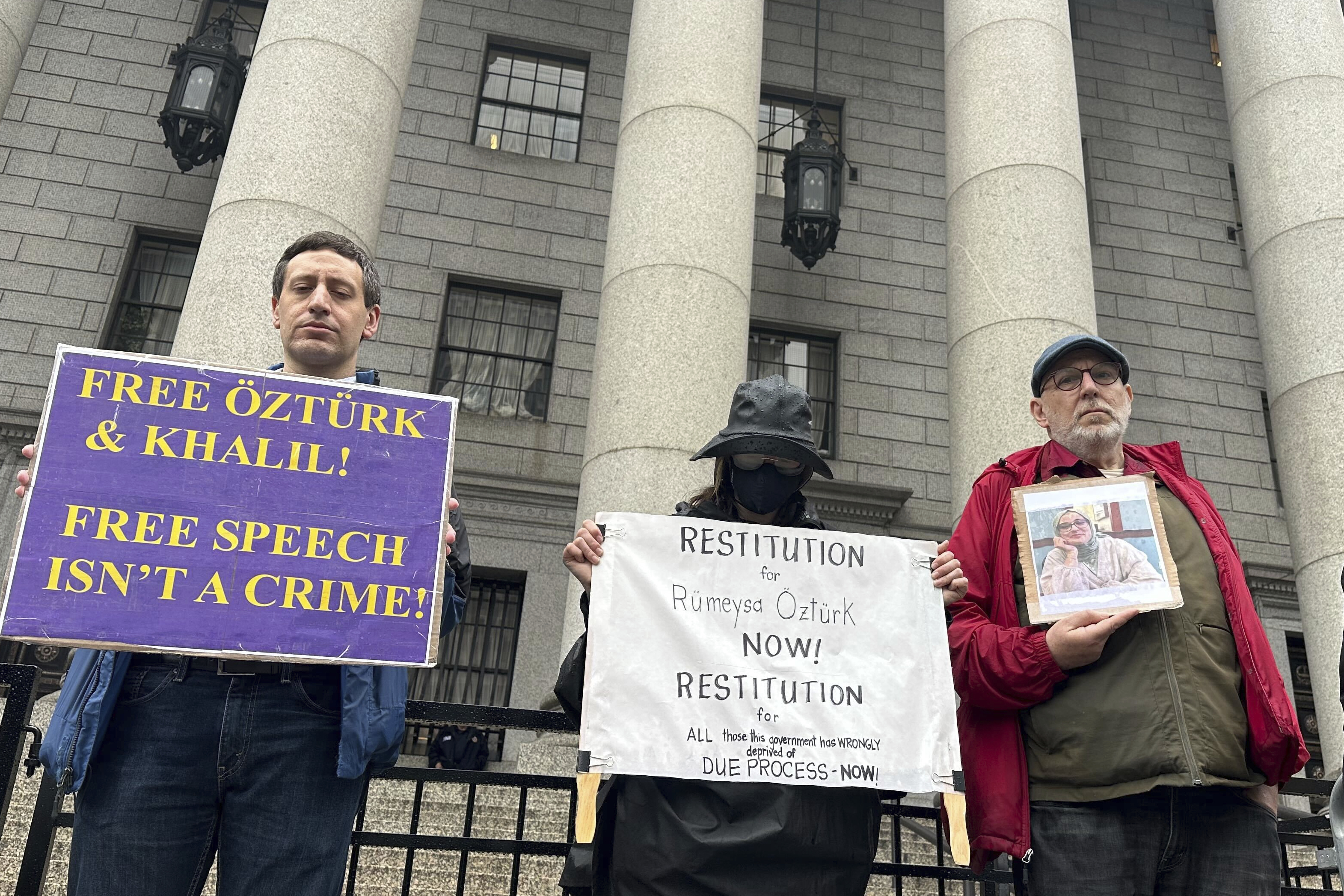 Protesters hold up signs outside court as a federal appeals court is scheduled to hear arguments in the cases of a Turkish Tufts University student who has been detained by immigration authorities for six weeks and a Palestinian student at Columbia University who was recently released from detention on Tuesday, May 6, 2025 in New York. (AP Photo/David Martin)