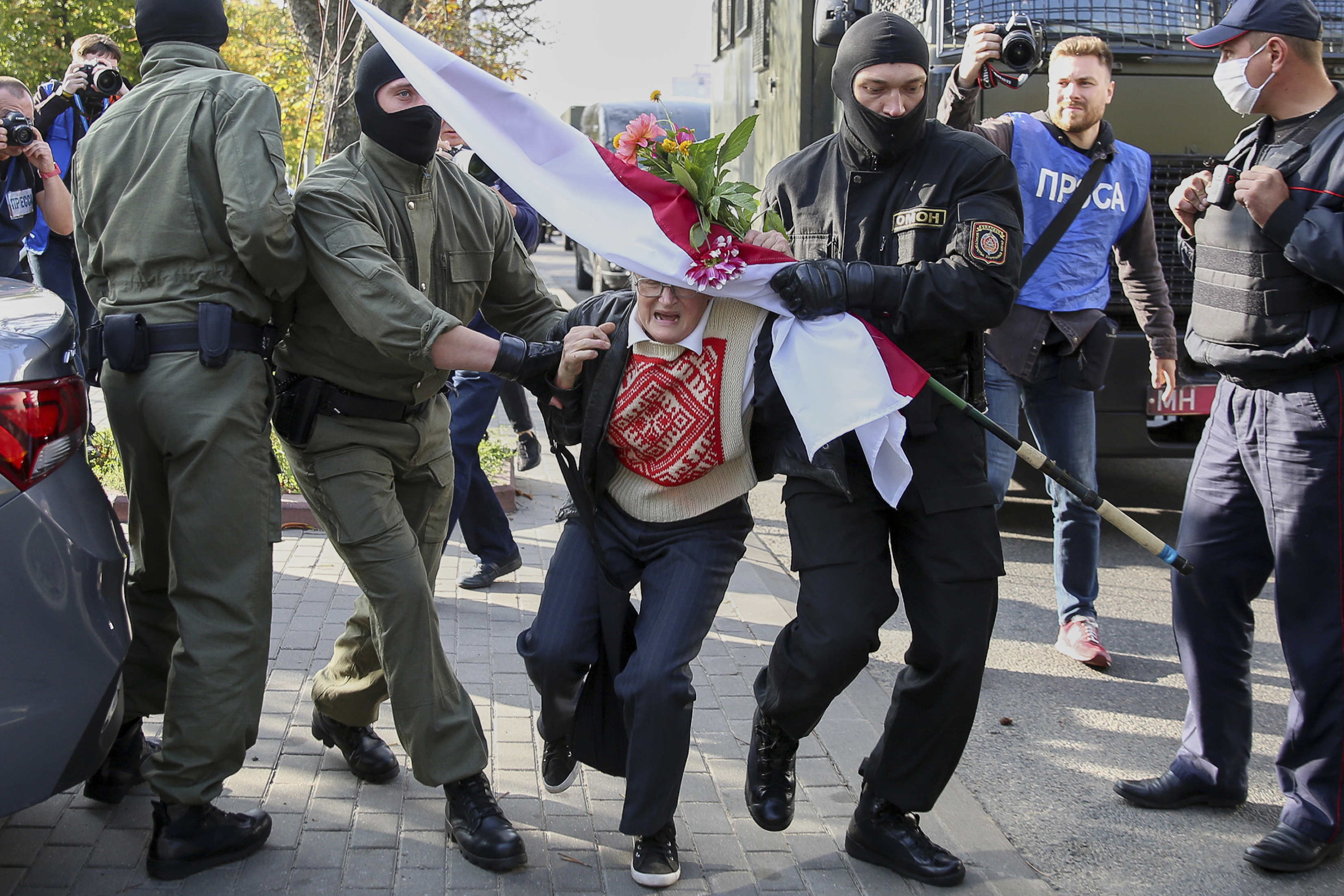 FILE - Police officers detain Nina Bahinskaya, 73, during an opposition rally to protest the official presidential election results in Minsk, Belarus, Saturday, Sept. 19, 2020. (AP Photo/TUT.by, File)