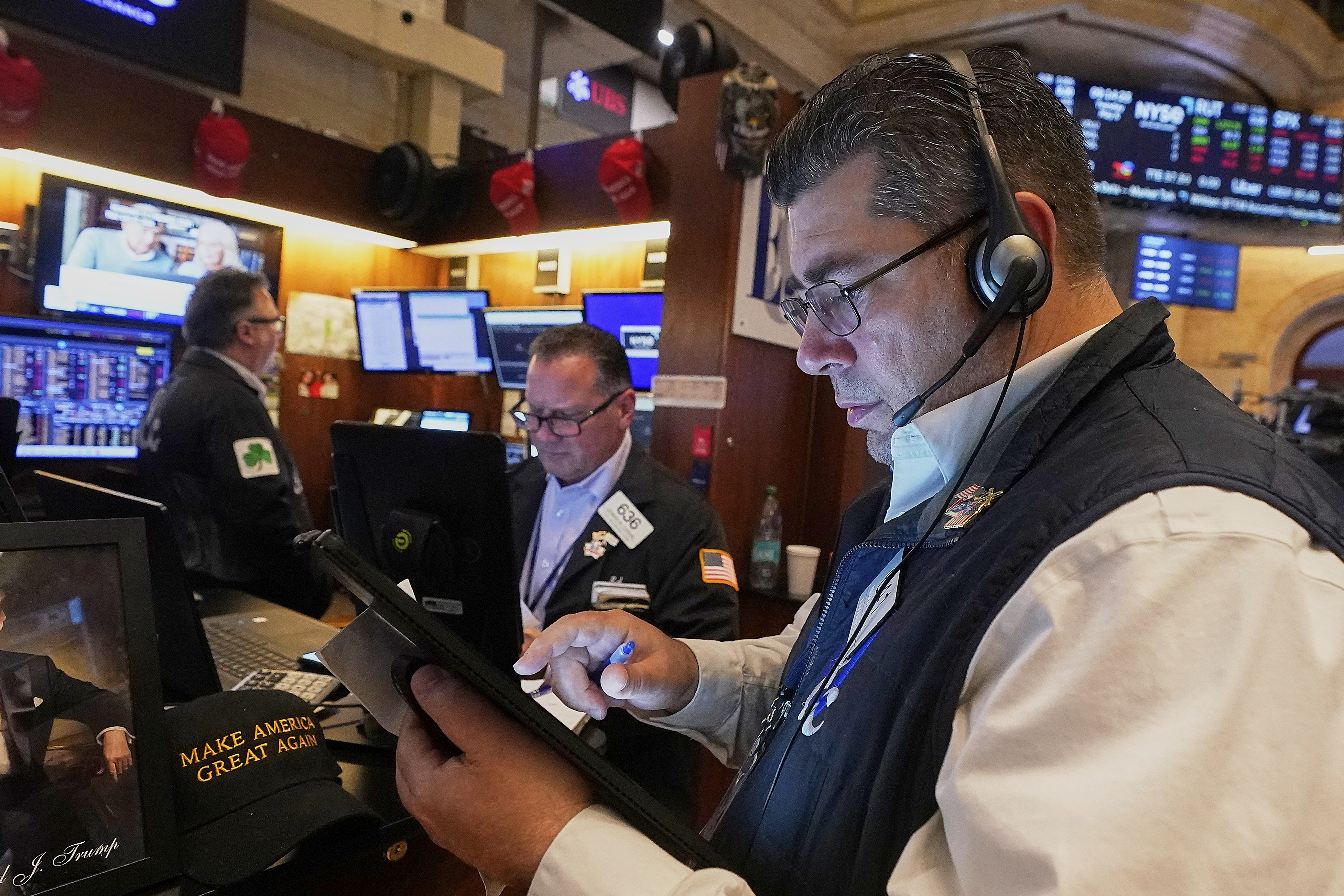 Trader Michael Capolino, right, works with colleagues on the floor of the New York Stock Exchange, Tuesday, May 6, 2025. (AP Photo/Richard Drew)