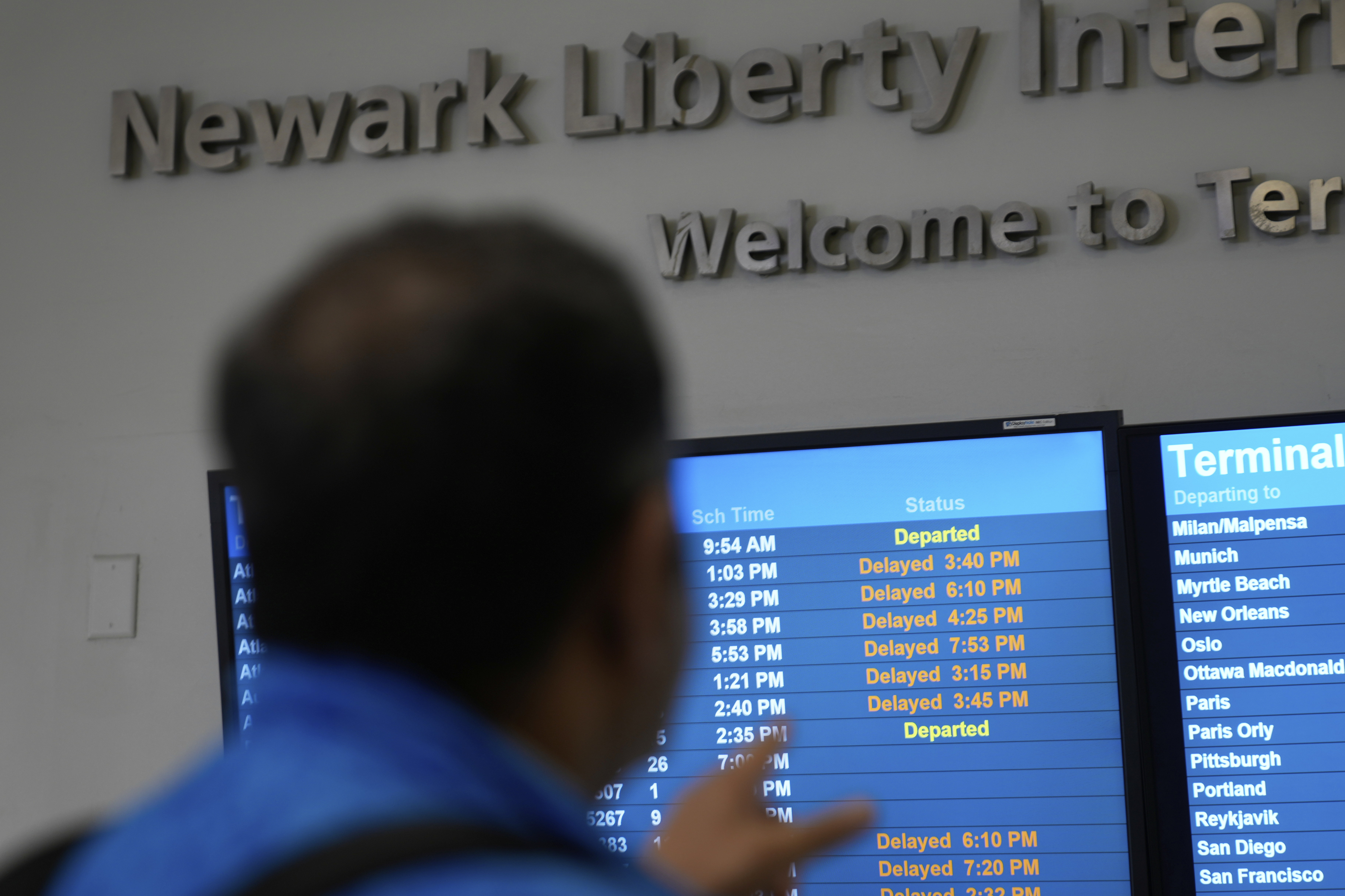 A display shows the status of flights at Newark Liberty International Airport in Newark, N.J., Monday, May 5, 2025. (AP Photo/Seth Wenig)