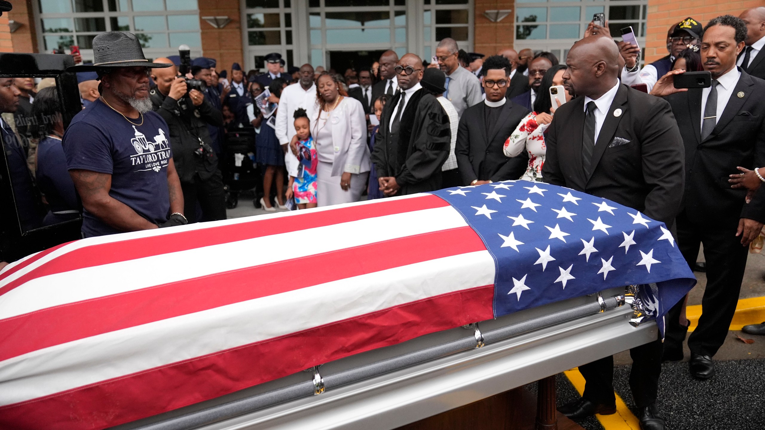 FILE - Friends and family of Roger Fortson watch as his casket leaves for the cemetery at New Birth Missionary Baptist Church on May 17, 2024, in Stonecrest, Ga. (AP Photo/Brynn Anderson, File)