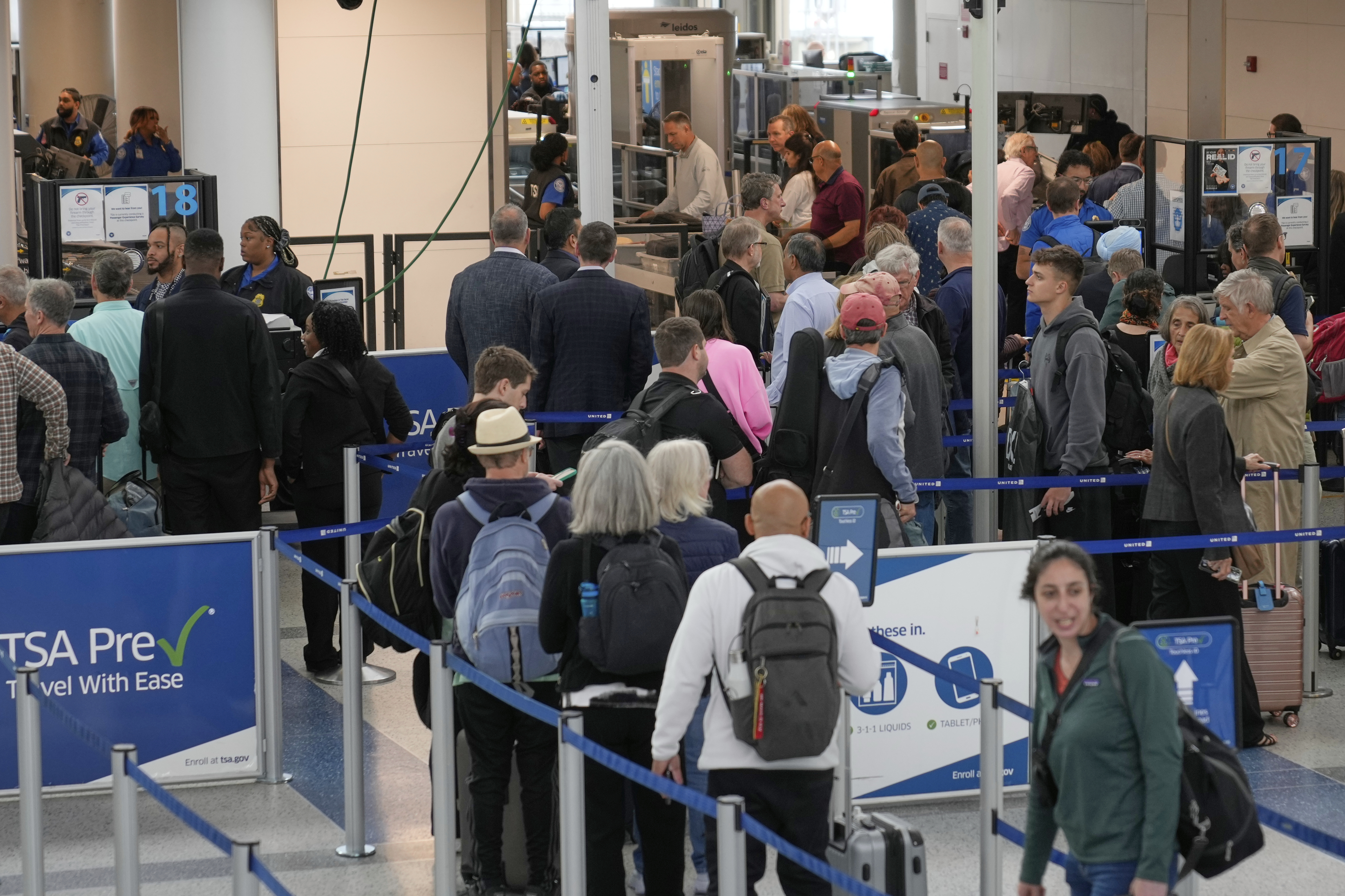 Travelers make their way through security at Newark Liberty International Airport in Newark, N.J., Monday, May 5, 2025. (AP Photo/Seth Wenig)