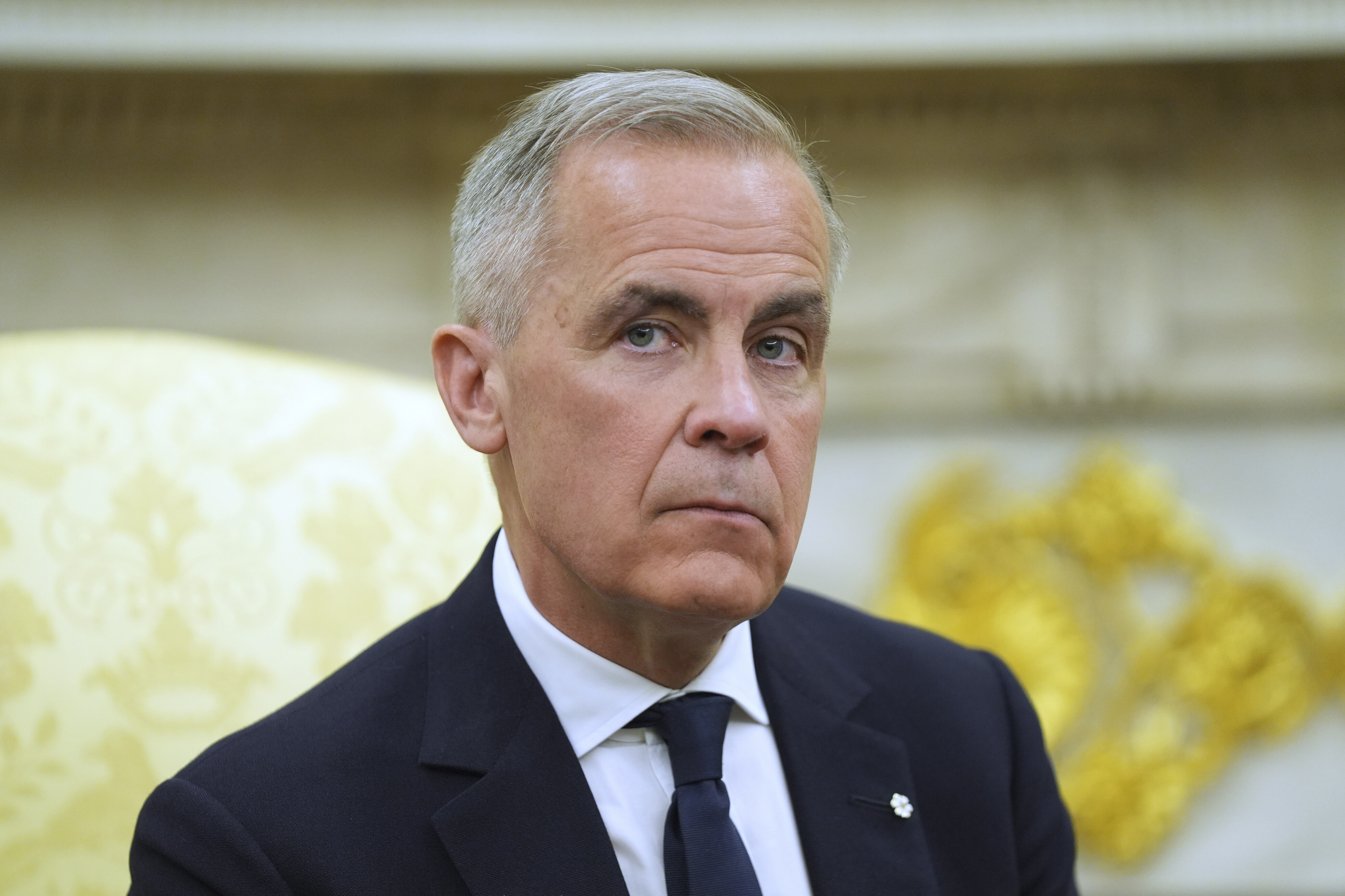 Canadian Prime Minister Mark Carney listtens to questions during a meeting with President Donald Trump in the Oval Office of the White House, Tuesday, May 6, 2025, in Washington. (AP Photo/Evan Vucci)