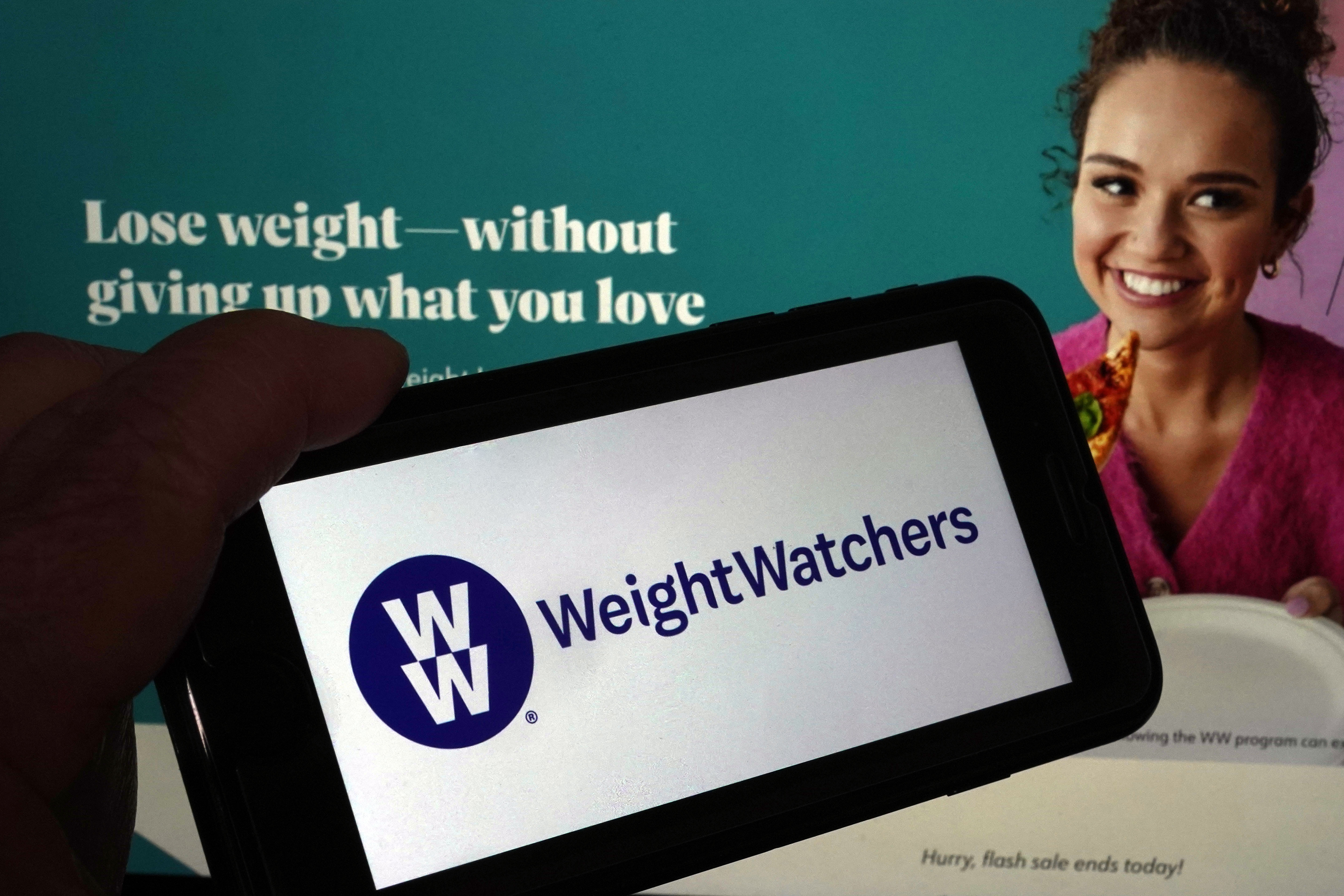 FILE - This image shows the logo of WeightWatchers on a mobile phone, and the company's website, in New York, March 7, 2023. (AP Photo/Richard Drew, File)