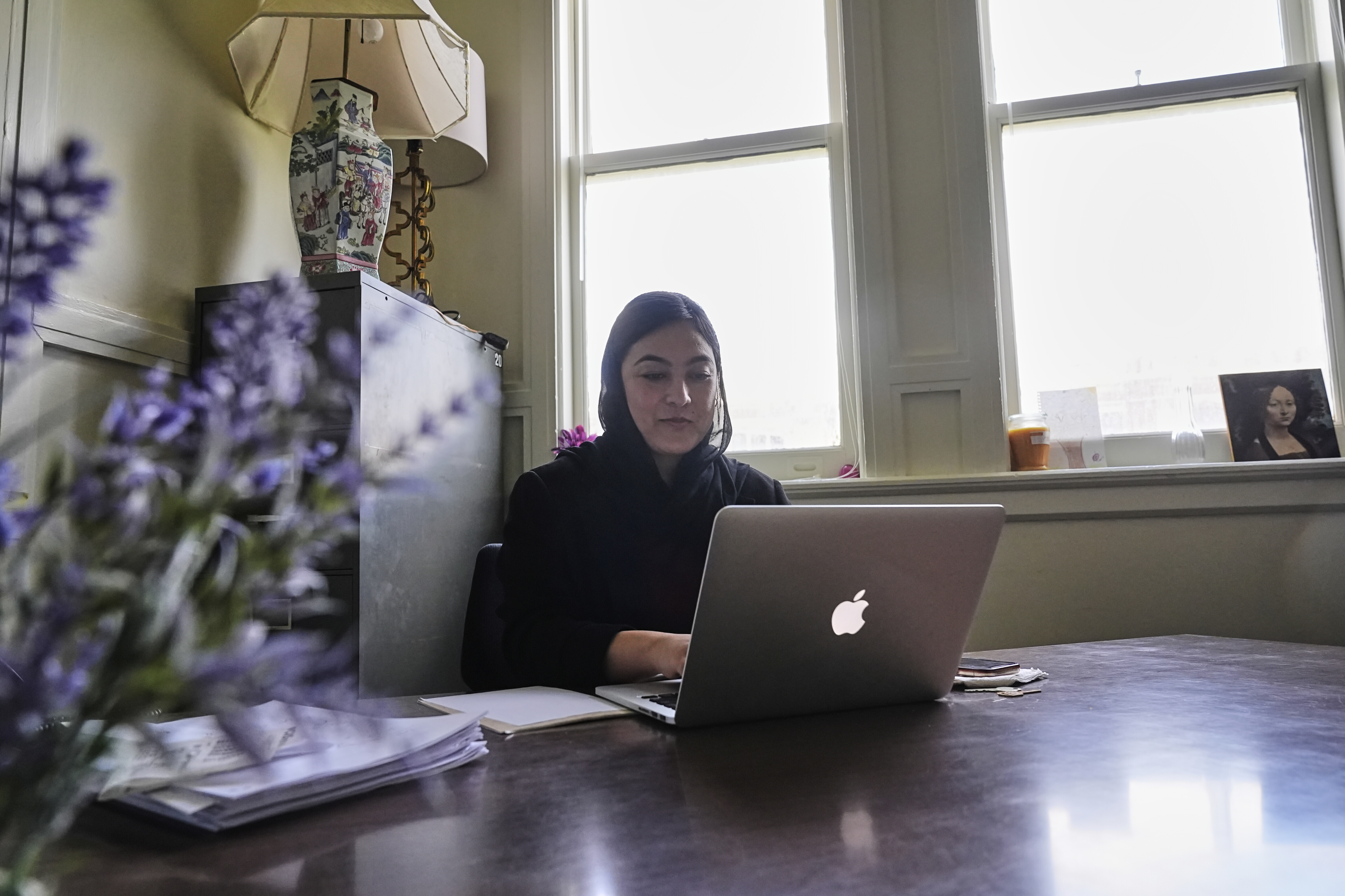 Negina Khalili works in her office in New Orleans, Thursday, May 1, 2025. (AP Photo/Gerald Herbert)
