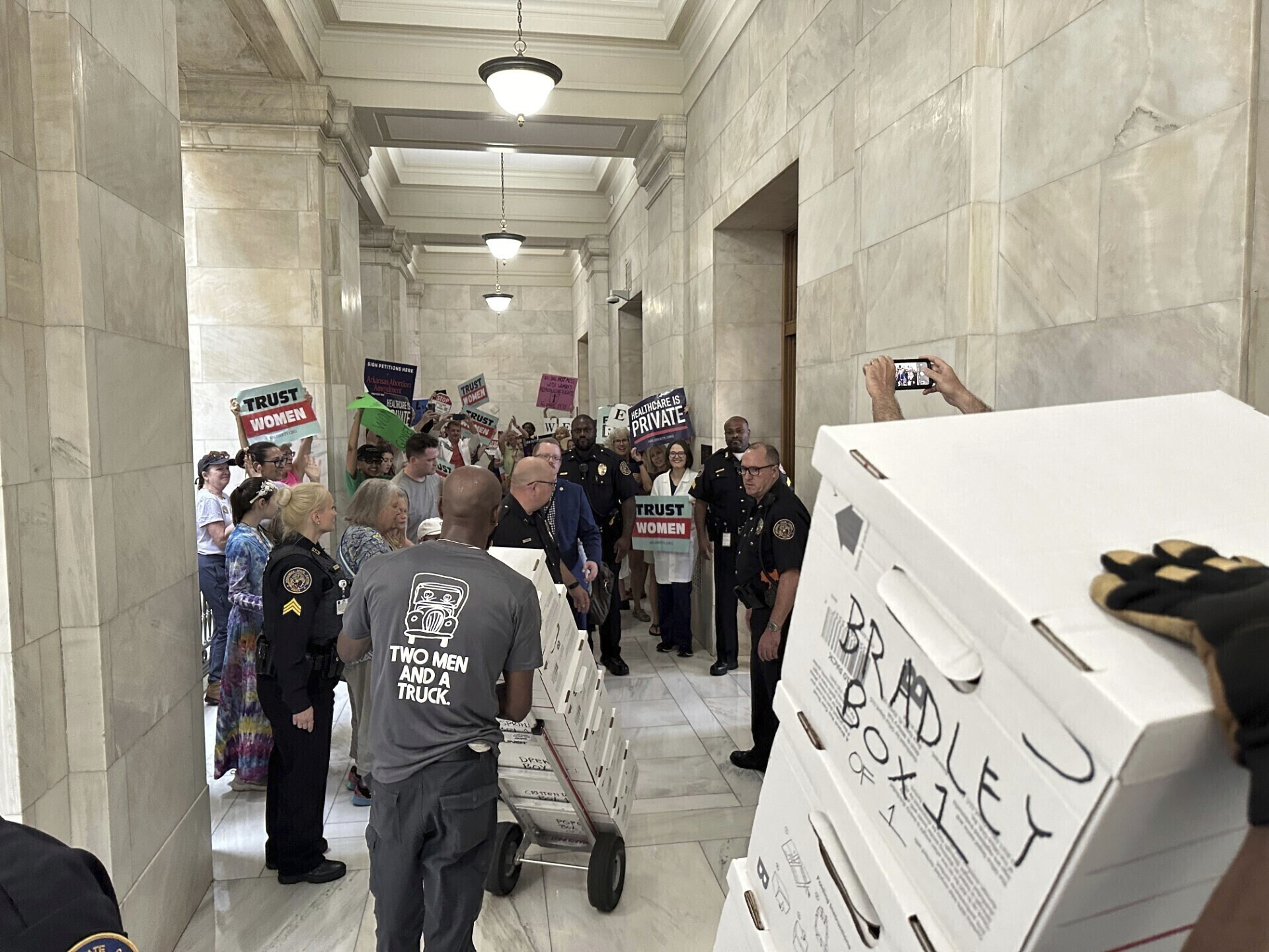 FILE - Boxes containing signatures supporting a proposed ballot measure to scale back Arkansas' abortion ban are delivered to a room in the state Capitol on July 5, 2024, in Little Rock, Ark. (AP Photo/Andrew DeMillo, File)